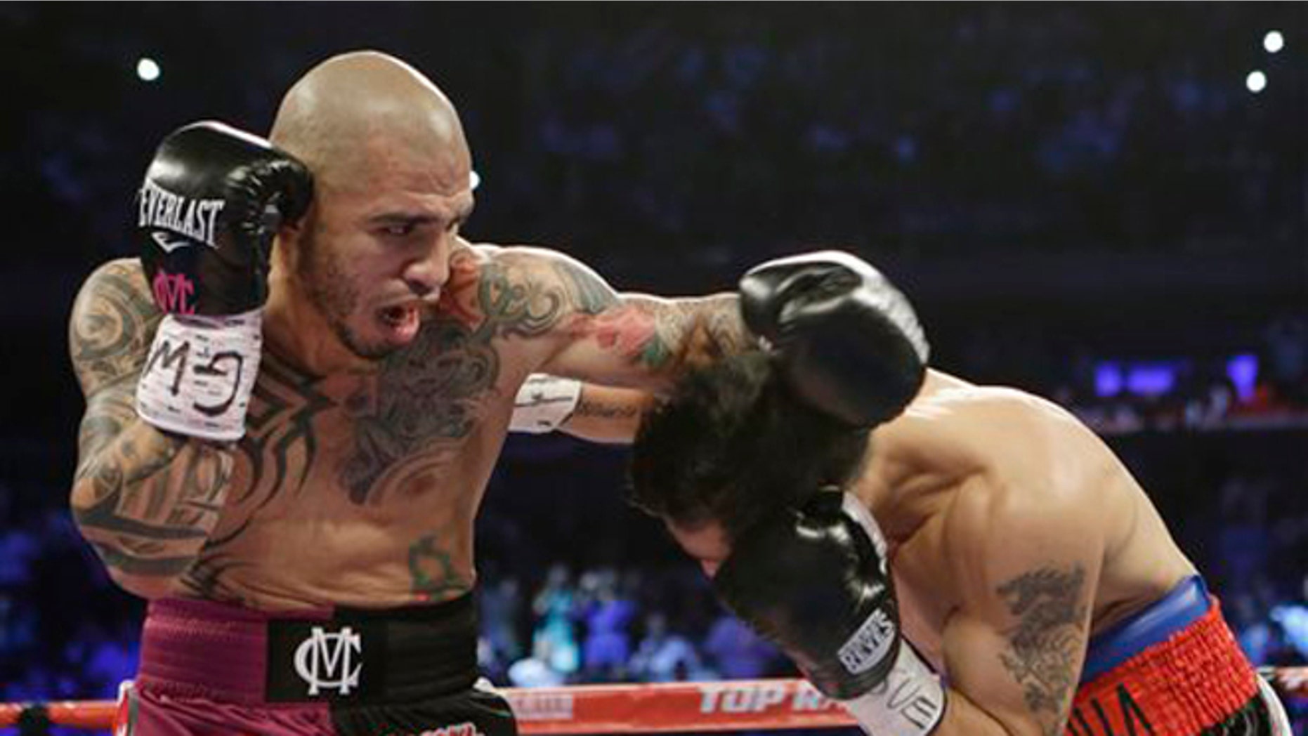 Miguel Cotto, left, of Puerto Rico, fights Sergio Martinez, of Argentina, during the first round of the WBC middleweight title boxing match Saturday, June 7, 2014, in New York. (AP Photo/Frank Franklin II)