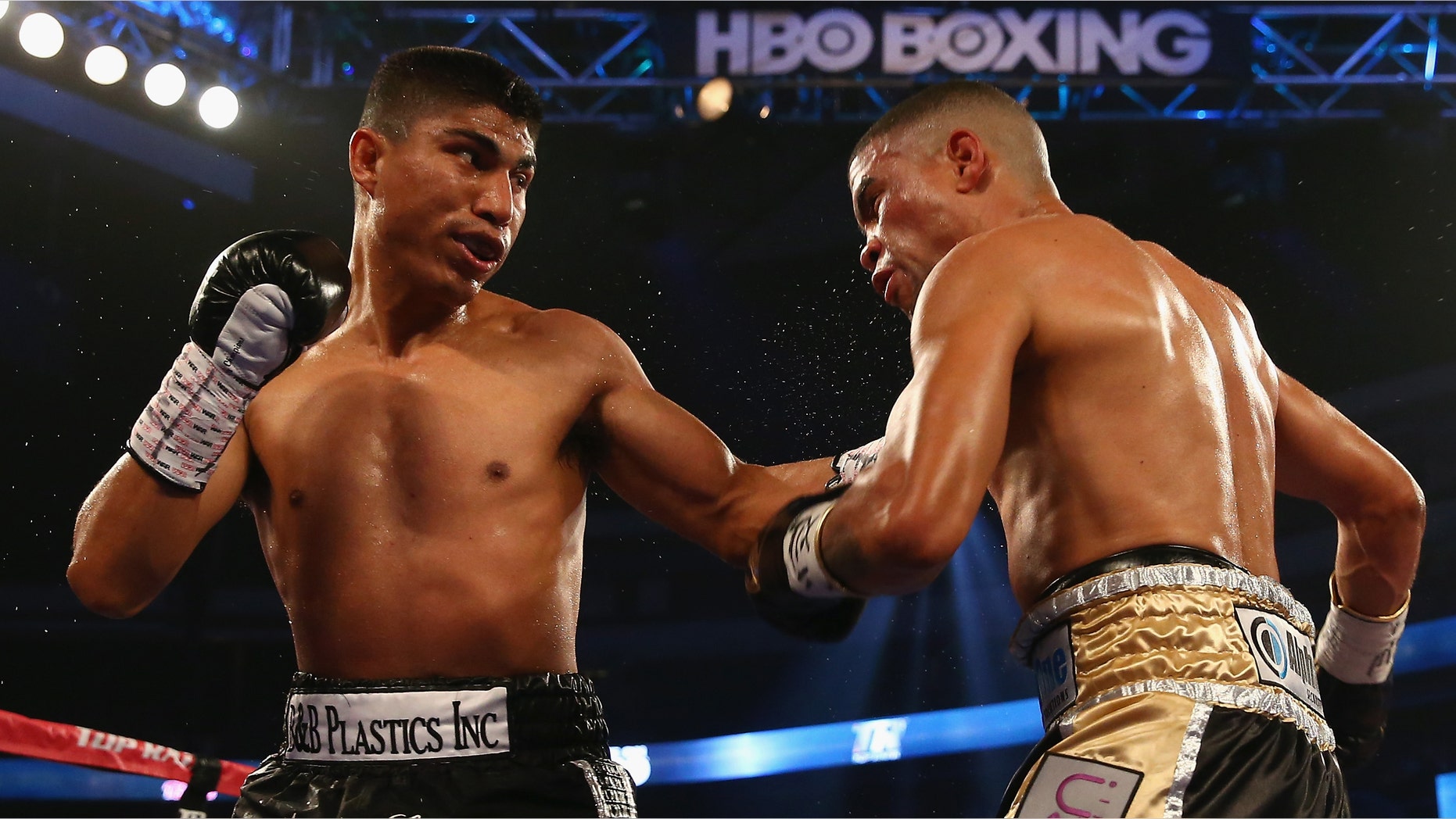 DALLAS, TX - JUNE 15: (L-R) Mikey Garcia connects with a left to the face of Juan Manuel Lopez during their Vacant WBO Featherweight Title bout at American Airlines Center on June 15, 2013 in Dallas, Texas. Garcia knocked out Lopez in the fourth round. (Photo by Tom Pennington/Getty Images)