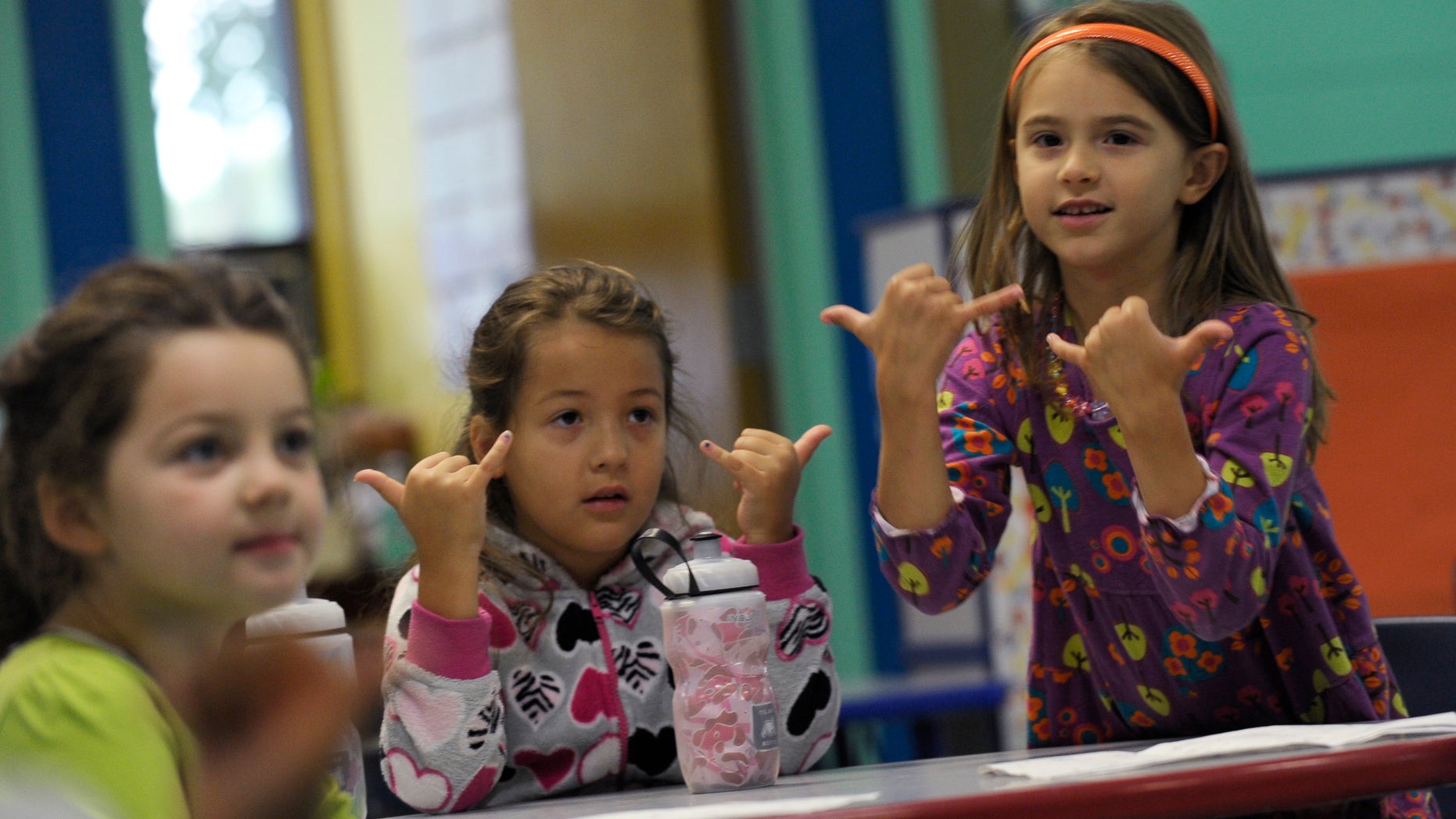 Oct. 9. 2013: In this photo from left, Brooklyn Olds, and Grace Whittaker learn sign language during a lesson at a home schooling co-operative at Andrews Air Force Base, Md.