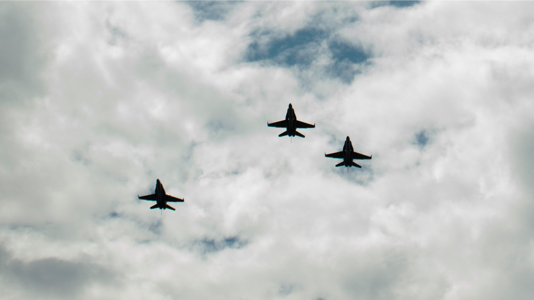 CINCINNATI, OH - AUGUST 31: In this handout photo provided by NASA, U.S. Navy F/A-18 jets from Strike Fighter Squadron (VFA) 106 and Strike Fighter Squadron (VFA) 34, from Naval Air Station Oceana (Va.) fly in a "Missing Man" formation over the Camargo Club following a memorial service celebrating the life of Neil Armstrong on August 31, 2012 in Cincinnati, Ohio. Armstrong, the first man to walk on the moon during the 1969 Apollo 11 mission, died Saturday, August 25. He was 82. (Photo by Bill Ingalls/NASA via Getty Images)
