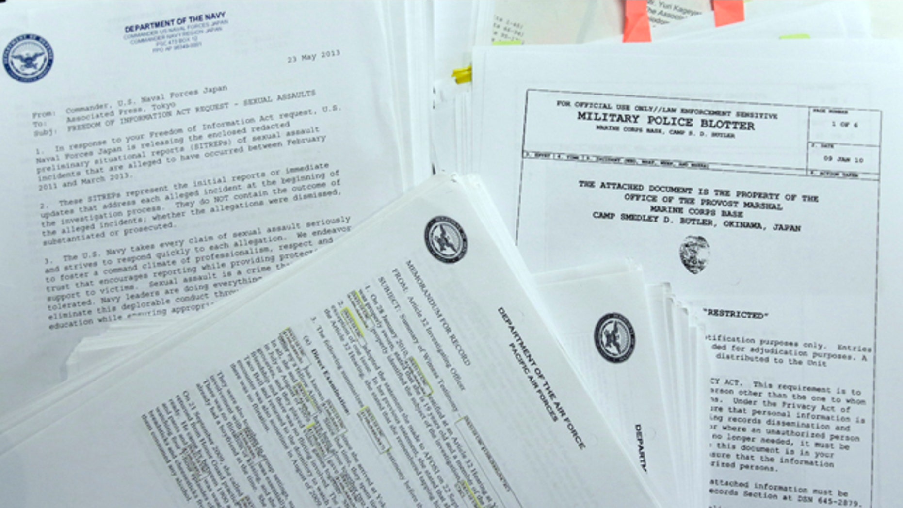 FILE - In this Jan. 29, 2014, file photo, parts of more than 1,000 summeries of sex-crime cases involving U.S. military personnel stationed in Japan, which The Associated Press obtained following Freedom of Information Act requests filed with the Army, Navy, Air Force, Marines and Naval Criminal Investigative Service, are displayed at the AP office in Tokyo. Reports of sexual assaults in the military rose 50 percent after the Pentagon began a vigorous campaign to get more victims to come forward, prompting defense officials to order a greater focus on prevention programs, including plans to review alcohol sales and policies. (AP Photo/Shizuo Kambayashi)