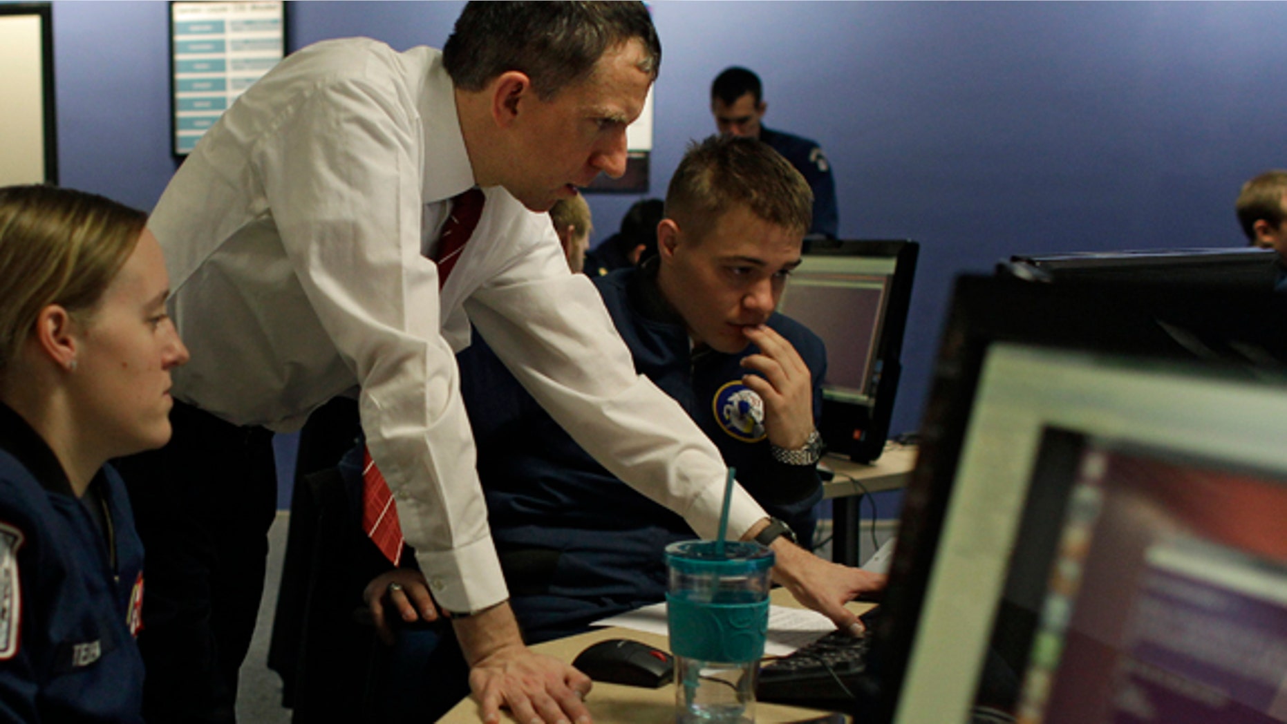 Feb. 20, 2013: Martin Carlisle, standing, a computer science professor at the Air Force Academy and director of the school's Center for Cyberspace Research, instructs cadets in cyber warfare, at the U.S. Air Force Academy, in Colorado Springs, Colo.