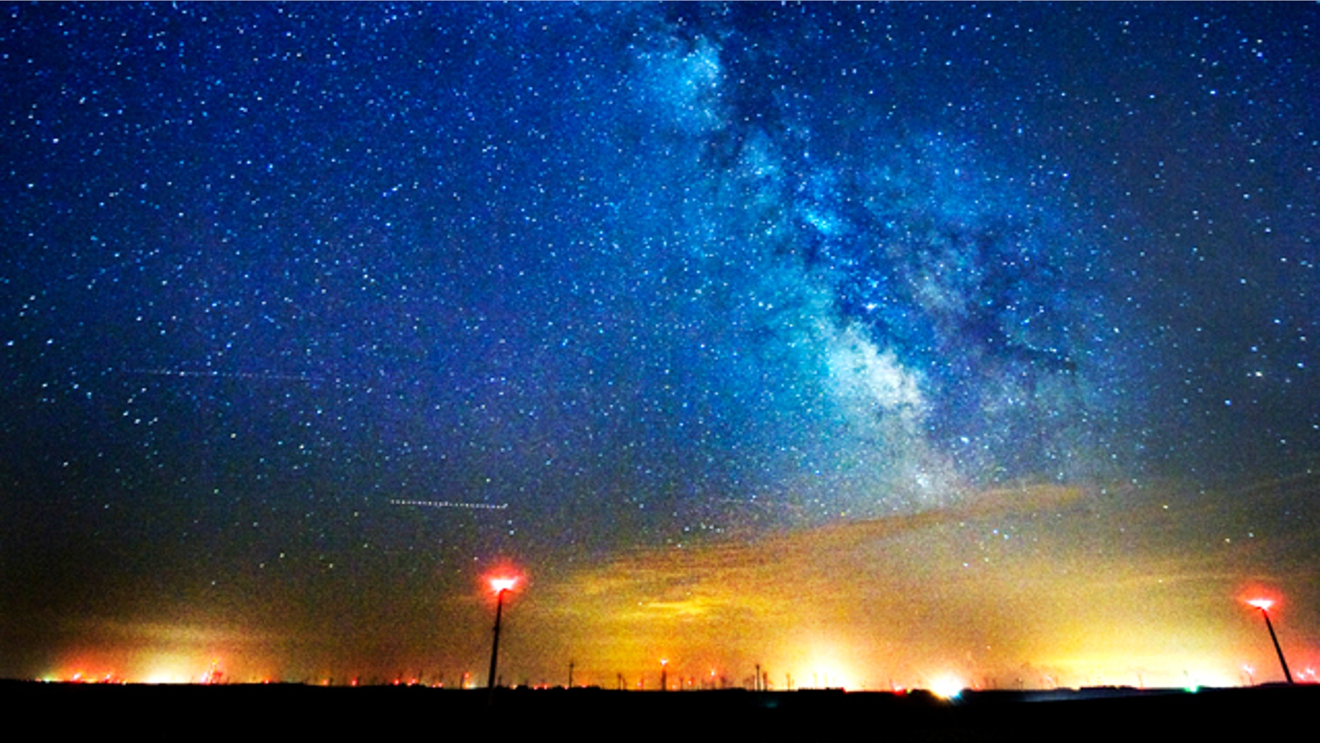 The Milky Way spins in the sky above wind turbines near Lake Benton and Hendricks, Minn. Scientists have estimated the first cosmic census of planets in our galaxy and the numbers are astronomical: at least 50 billion planets in the Milky Way. At least 500 million of those planets are in the not-too-hot, not-too-cold zone where life could exist, scientists announced Saturday, Feb. 19, 2011.