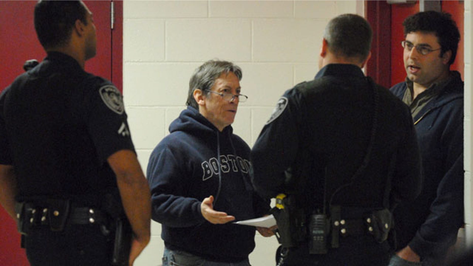 Oct. 17: Attorney John McKay, second from left, and Alaska Dispatch founder and editor Tony Hopfinger, right, talk to Anchorage Police after Hopfinger was detained and handcuffed by a security guard at Alaska Senate candidate Joe Miller's campaign event in Anchorage, Alaska.