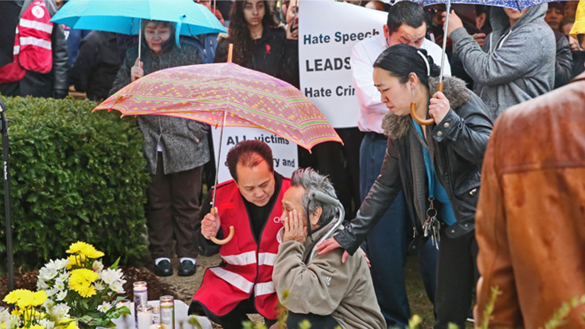 An man is assisted by members of the Vue family, as he weeps in the rain in front of a memorial for three people who were fatally shot, Sunday, March 13, 2016, in Milwaukee. A crowd gathered for a candlelight vigil Sunday evening to remember Jesus Manso-Perez, Phia Vue and Mai Vue, who were gunned down at their apartment complex on Sunday, March 6. (Michael Sears/Milwaukee Journal-Sentinel via AP) MANDATORY CREDIT