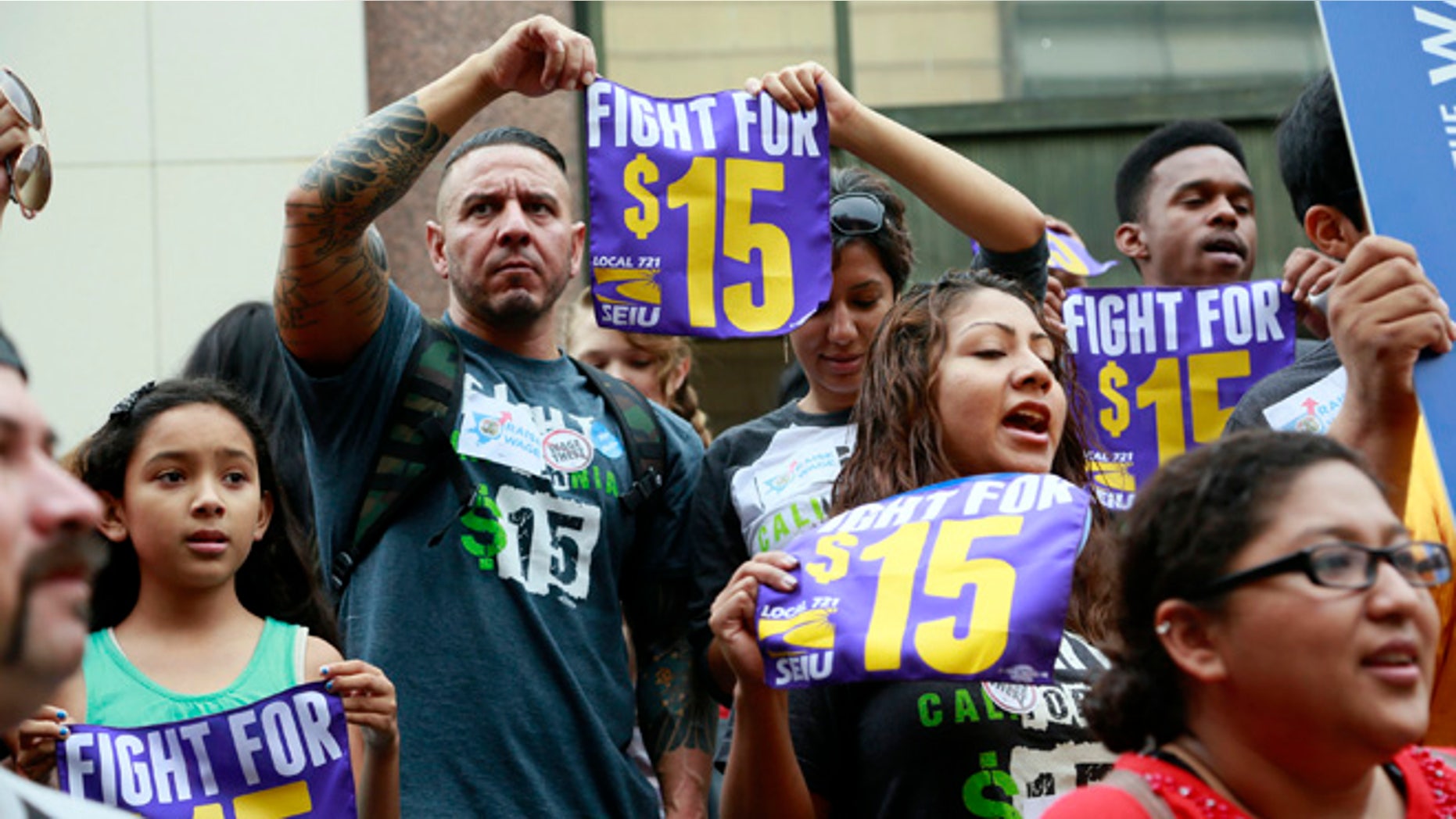 FILE - In this Tuesday, July 21, 2015 file photo, workers hold a rally in Los Angeles in support of the Los Angeles County Board of Supervisors' proposed minimum wage ordinance. On Saturday, March 26, California legislators and labor unions reached an agreement that will take the state's minimum wage from $10 to $15 an hour. (AP Photo/Nick Ut)