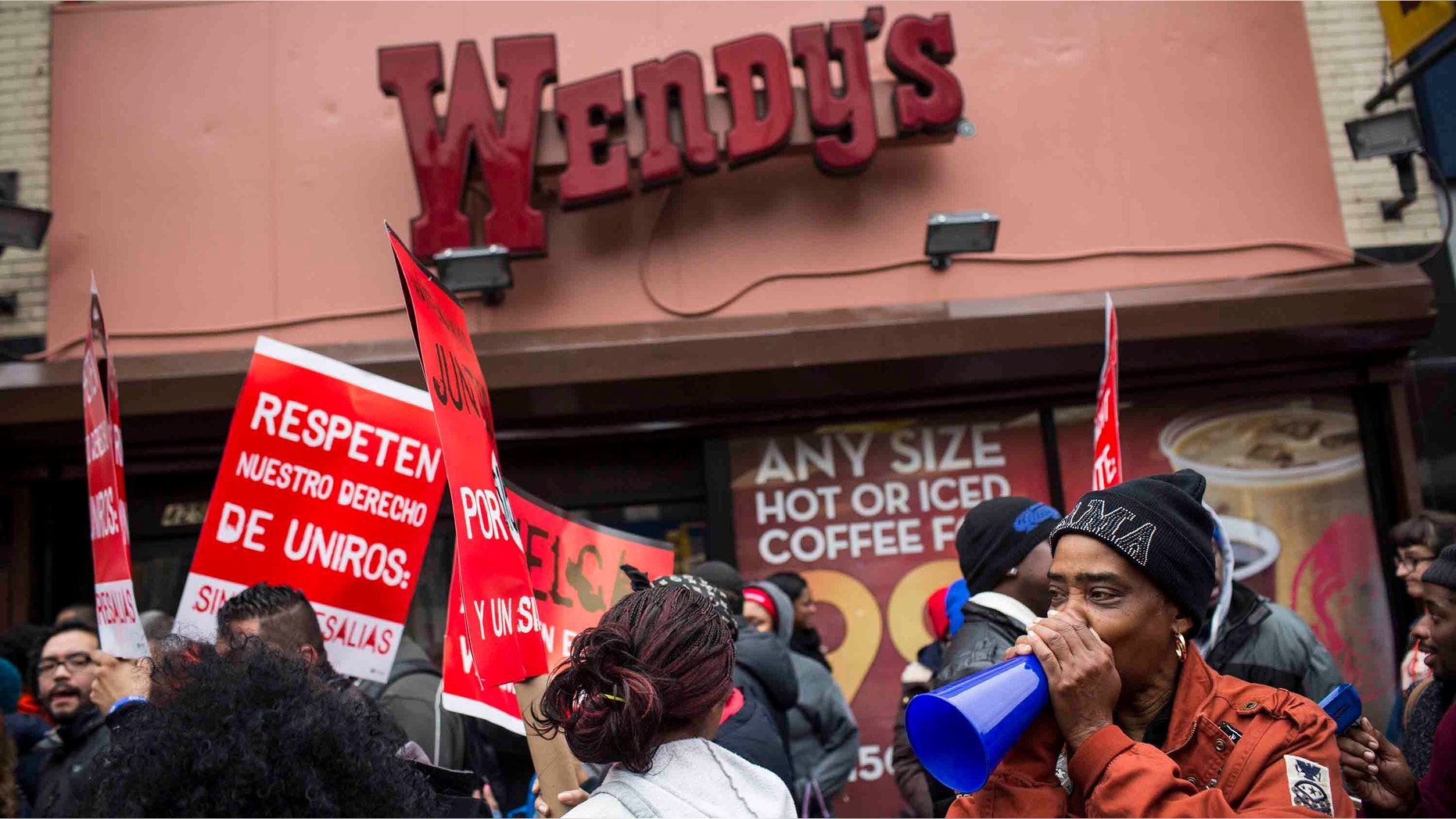NEW YORK, NY - DECEMBER 05: Protesters rally outside of a Wendy's in support of raising fast food wages from $7.25 per hour to $15.00 per hour on December 5, 2013 in the Brooklyn borough of New York City. A growing number of fast food workers in the United States have been staging protests outside restaurants, calling for a raise in wages, claiming it is impossible to live resonably while earning minimum wage. (Photo by Andrew Burton/Getty Images)