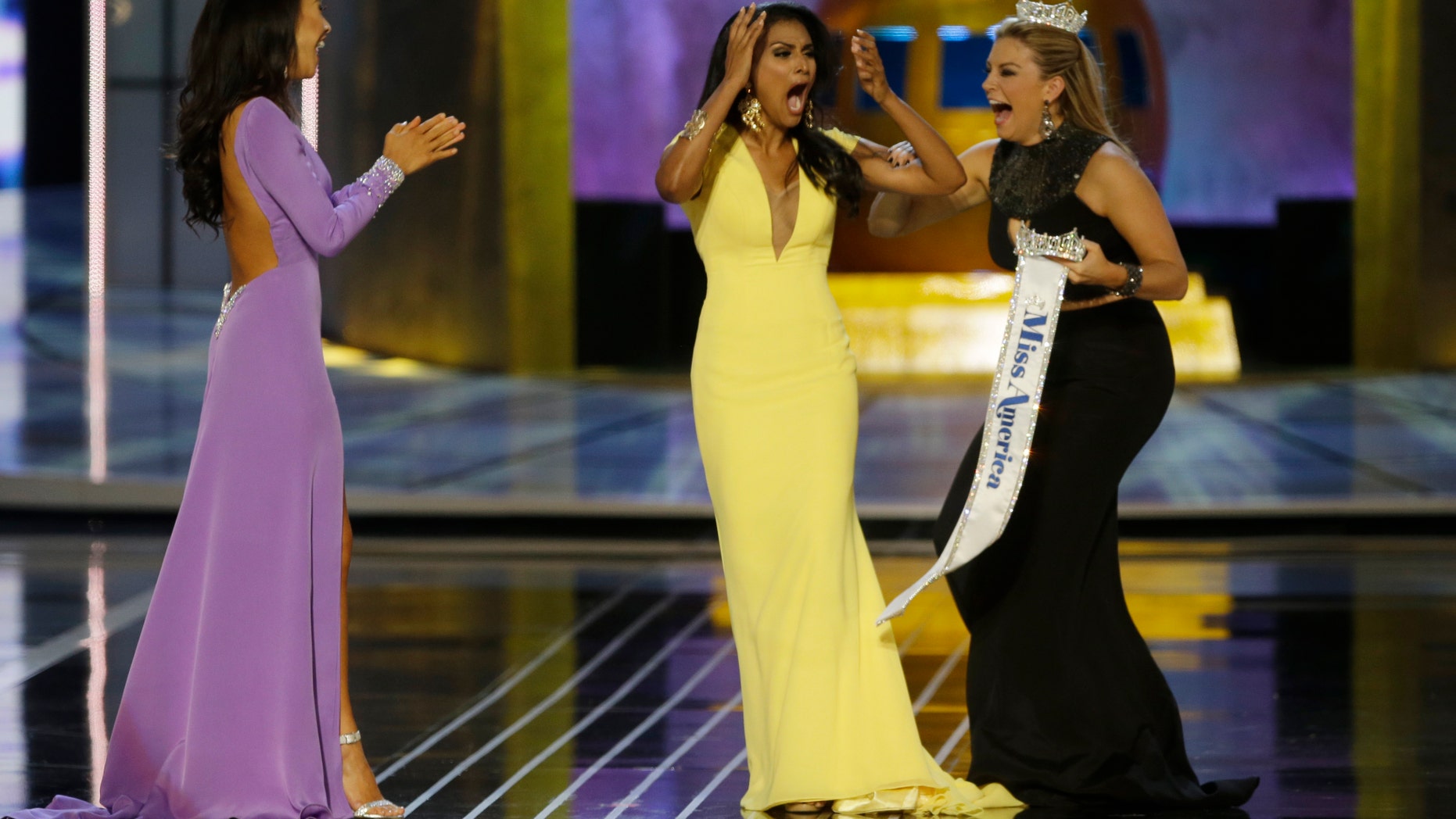 Miss New York Nina Davuluri, center, reacts after being named Miss America 2014 pageant as Miss California Crystal Lee, left, and Miss America 2013 Mallory Hagan celebrate with her, Sunday, Sept. 15, 2013, in Atlantic City, N.J. (AP Photo/Mel Evans)