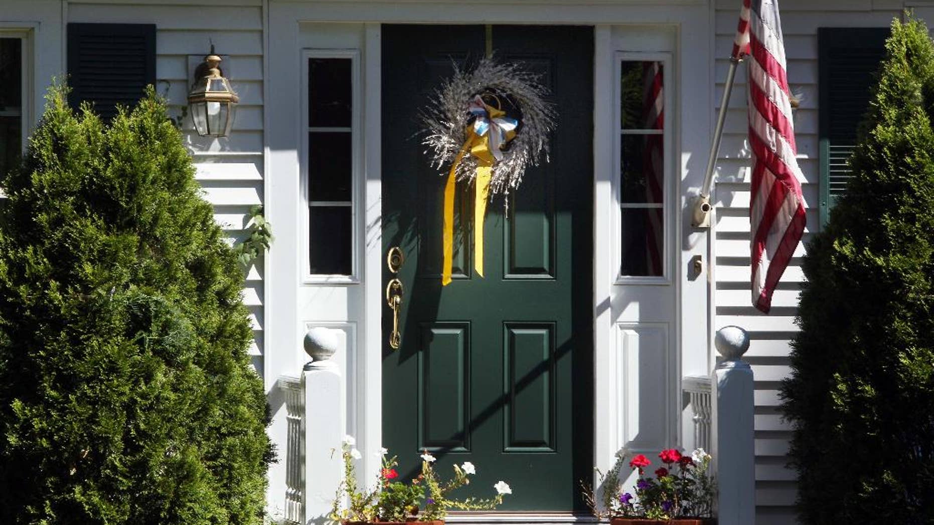 A ribbon is seen on the front door of the family home of freelance journalist James Foley, Wednesday, Aug. 20, 2014 in Rochester, N.H. Foley was abducted in November 2012 while covering the Syrian conflict. On Tuesday, Aug. 19, militants with the Islamic State extremist group released a video showing Islamic State militants beheading Foley in an act of revenge for U.S. airstrikes in northern Iraq . (AP Photo/Jim Cole)