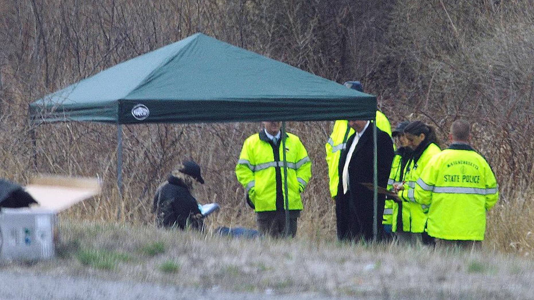Massachusetts State Police stand along Interstate 190 where police said a child's body was found Friday, April 18, 2014, near Sterling, Mass. Worcester County District Attorney Joseph Early Jr., said the body has not been positively identified as Jeremiah Oliver, of Fitchburg, but that the height and weight of the body was consistent with Oliver's size. Jeremiah Oliver was last seen by relatives in September 2013 but wasn't reported missing until December. His mother Elsa Oliver and her boyfriend Alberto Sierra are both charged in the case. (AP Photo/Worcester Telegram & Gazette, Tom Rettig)
