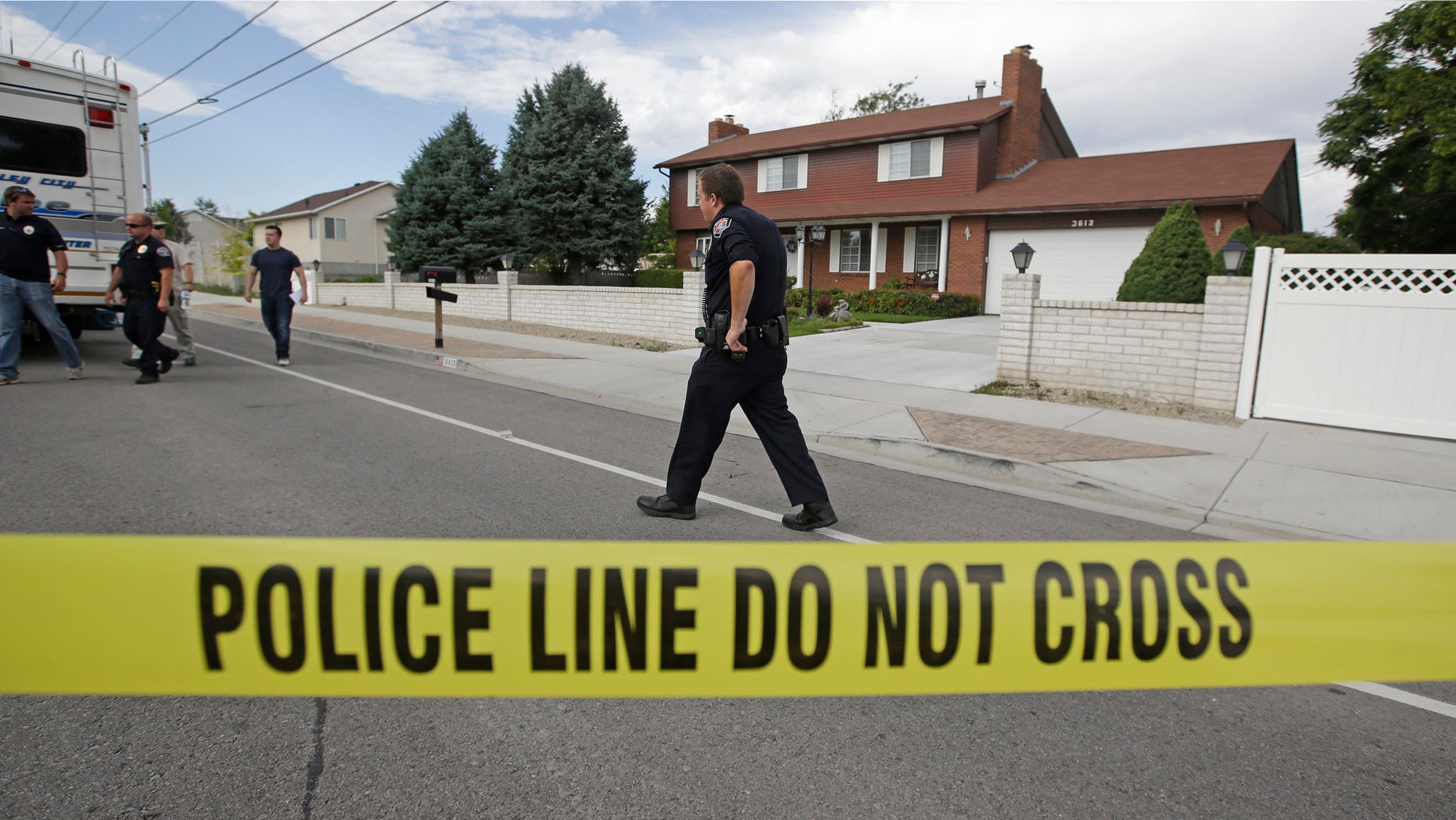 Police officials gather during an investigation after a 12-year-old girl was found dead Friday, July 17, 2015, in West Valley City, Utah. The search for the missing 12-year-old girl is now being investigated as a homicide after West Valley City police discovered the girl's body in a horse pasture. Police Chief Lee Russo says the girl's mother approached two officers at a convenience store near their home around 1:30 a.m. Friday,July 17, 2015. She told officers her daughter had been missing since midnight. (AP Photo/Rick Bowmer)