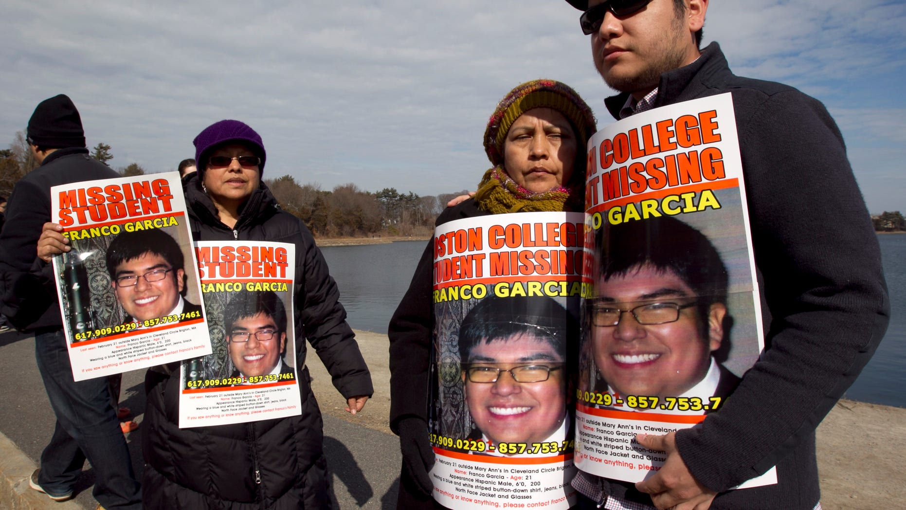Feb. 27, 2012: Luzmila Garcia, of Newton, Mass., center right, mother of missing Boston College student Franco Garcia, displays a placard of her son along with Franco's aunt Carmen Espinoza, left, and his cousin Pablo Marchena, right, at the Chestnut Hill Reservoir where Mass. state police are searching the water for the missing student, in Boston. Garcia, 21, has not been seen since early Wednesday, at a bar popular with Boston College students near campus.