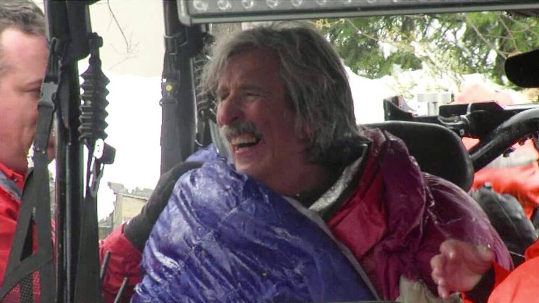 This image from video provided by KTXL Fox 40 Sacramento, shows trail runner Robert Root after being rescued Tuesday, April 1, 2014, near Foresthill, Calif., in Placer County. Root was found alive in snowy conditions, two days after he went missing near a trail in a mountainous region of Northern California, authorities said. Root, 55, of Modesto, Calif., was wearing only a light running shirt, shorts and running shoes when he was discovered by rescuers on the Western States trail. (AP Photo/KTXL Fox 40 Sacramento)