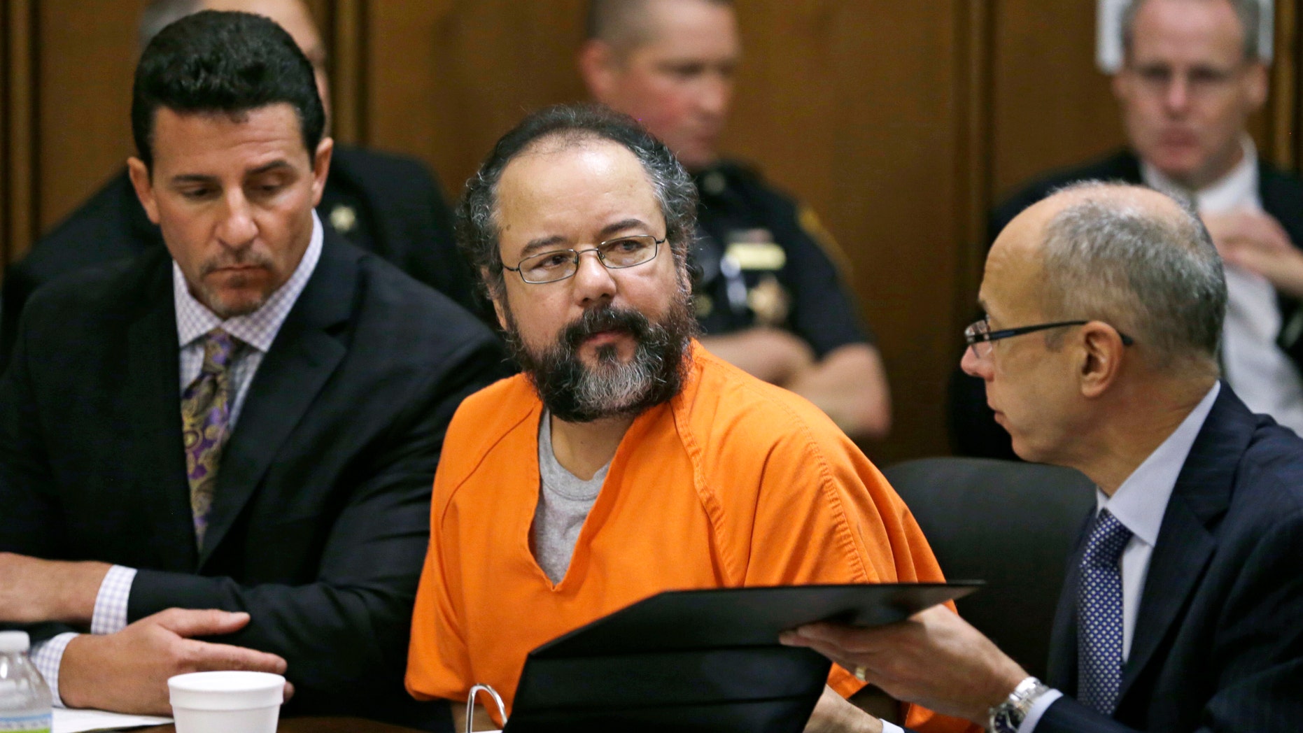 Aug. 1, 2013: Ariel Castro, center, listens in the courtroom during the sentencing phase of his trial, in Cleveland. Defense attorney's Craig Weintraub, left, and Jaye Schlachet sit beside Castro.