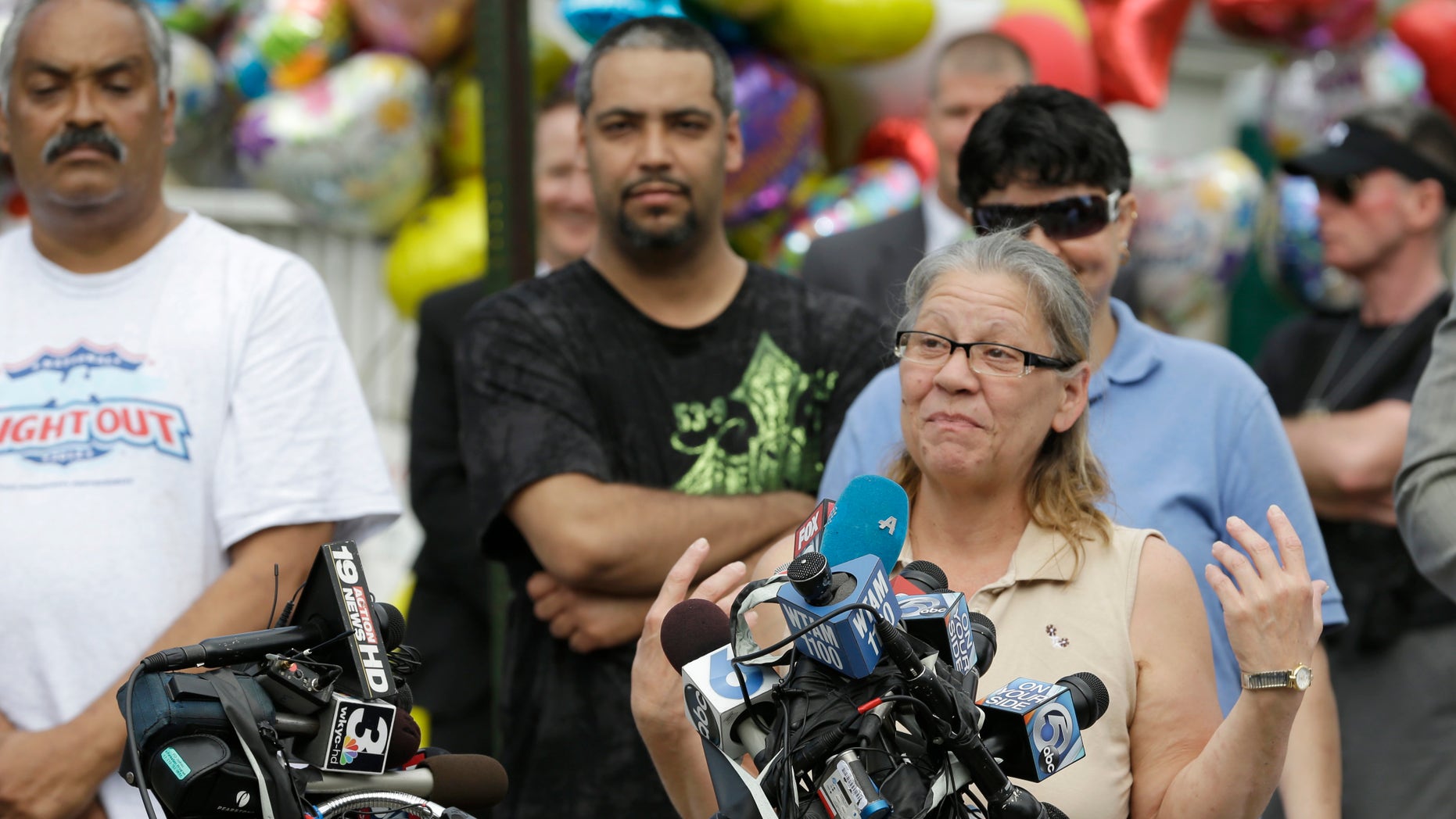 Nancy Ruiz, mother of Gina, speaks to the media after bringing her daughter home Wednesday, May 8, 2013, in Cleveland. DeJesus was one of three women held captive for about a decade at a run-down Cleveland house. Kidnapping and rape charges were filed Wednesday against the man arrested after the missing women were found alive at his home. (AP Photo/Tony Dejak)