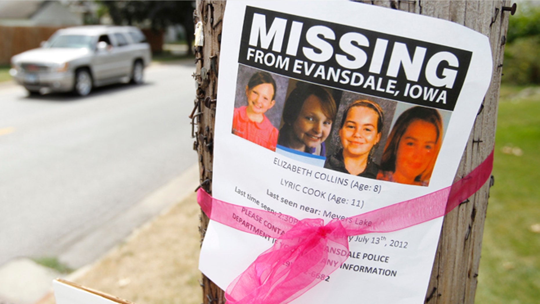 July 19: A sign is posted in Waterloo, Iowa, for the missing cousins Lyric Cook-Morrissey, 10, and Elizabeth Collins, 8.