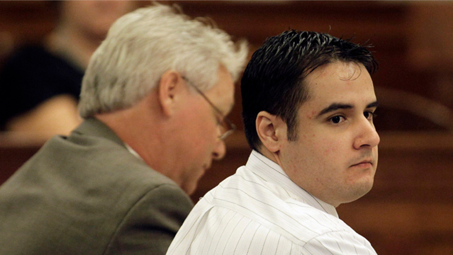 Aug. 13, 2010: Former Marine Cesar Laurean, right, listens during his trial at the Wayne County Courthouse in Goldsboro, N.C.