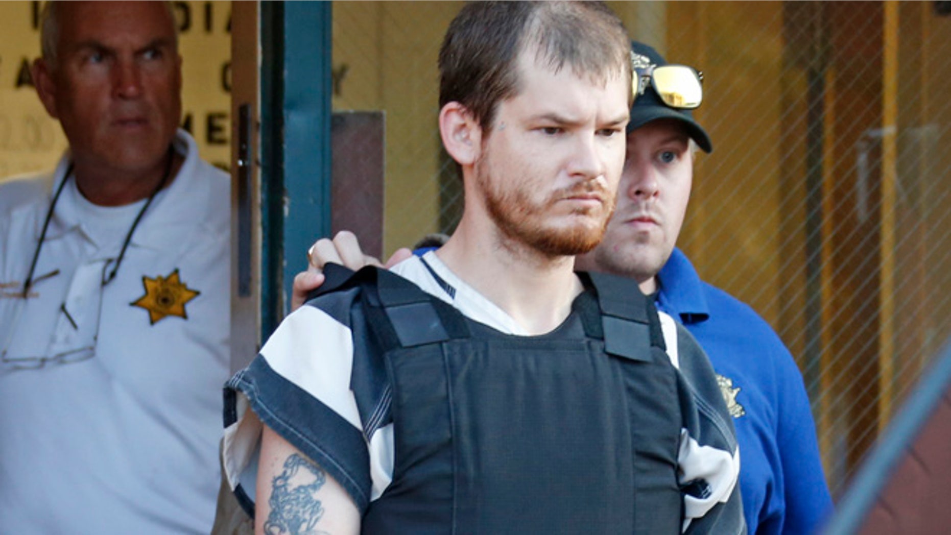 Sept. 11: Smith County Sheriff Charlie Crumpton, left, watches as Timothy Ray Jones Jr., is escorted by lawmen out of the Smith County Jail to a vehicle for transport to Lexington County, S.C.