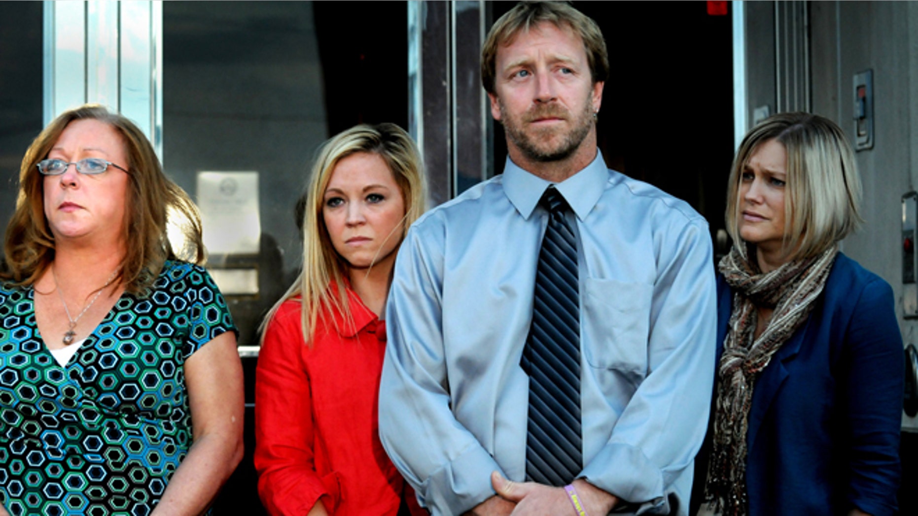 Oct. 2, 2013: From left, Kira Steger's mother, Marcie Steger, sister Keri Anne Steger, father Jay Steger and victim's advocate Jen Mallenger listen to their lawyer speak to the media at the Ramsey County Courthouse in St. Paul, Minn.