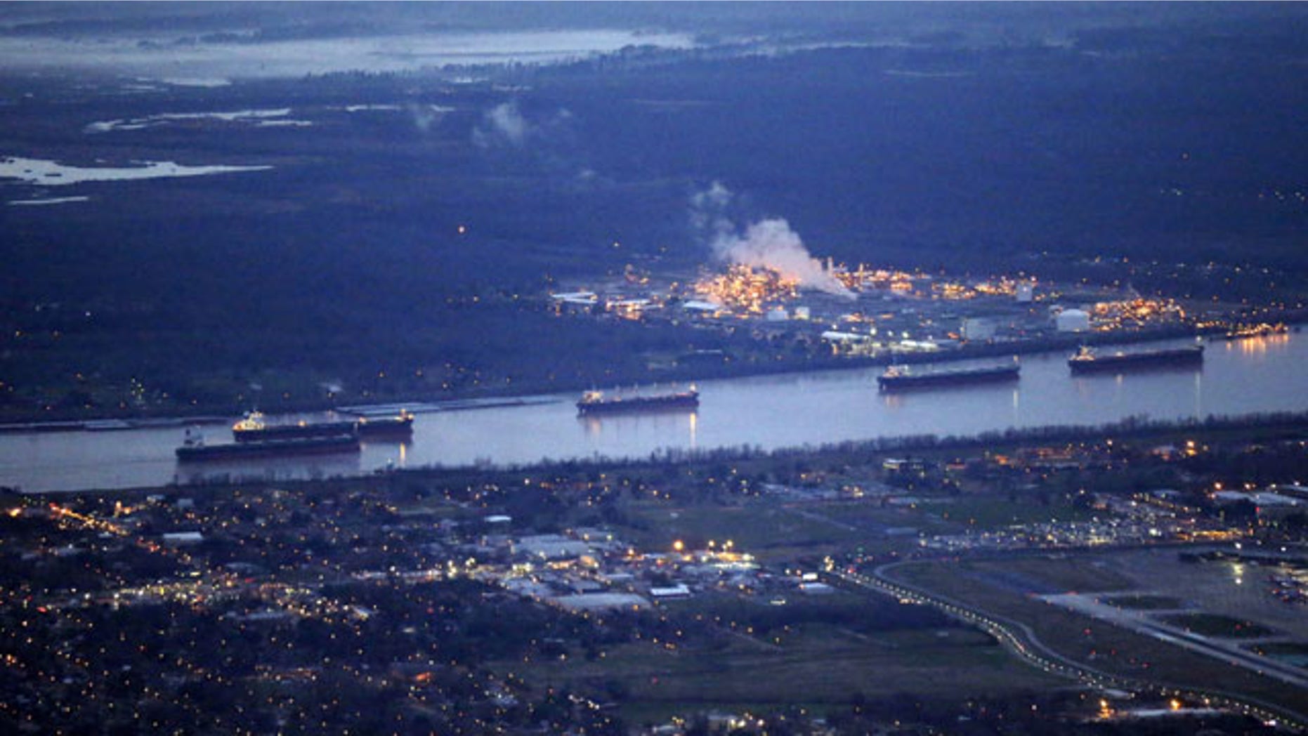 February 23, 2014: In this aerial photo, river traffic is halted along the Mississippi River in New Orleans, due to a barge leaking oil upriver in St. James Parish, La. The collision happened Saturday afternoon near Vacherie, 47 miles west of New Orleans. (AP Photo/Gerald Herbert)