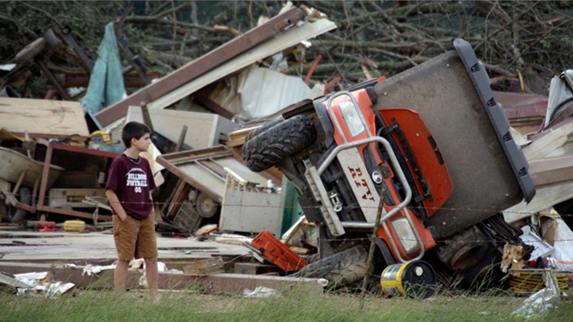 April 27: A young resident surveys the damage to a home near Bond, Miss.