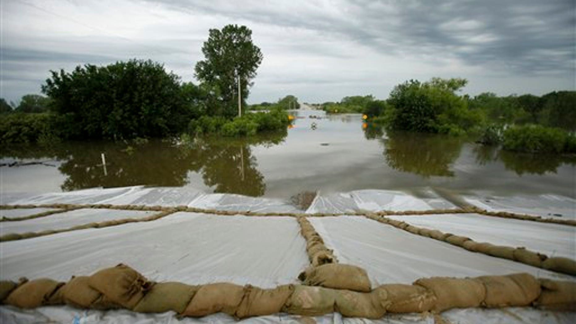 June 16: Floodwaters from the Missouri River covering Highway 333 outside of town approach a levee in Hamburg, Iowa.