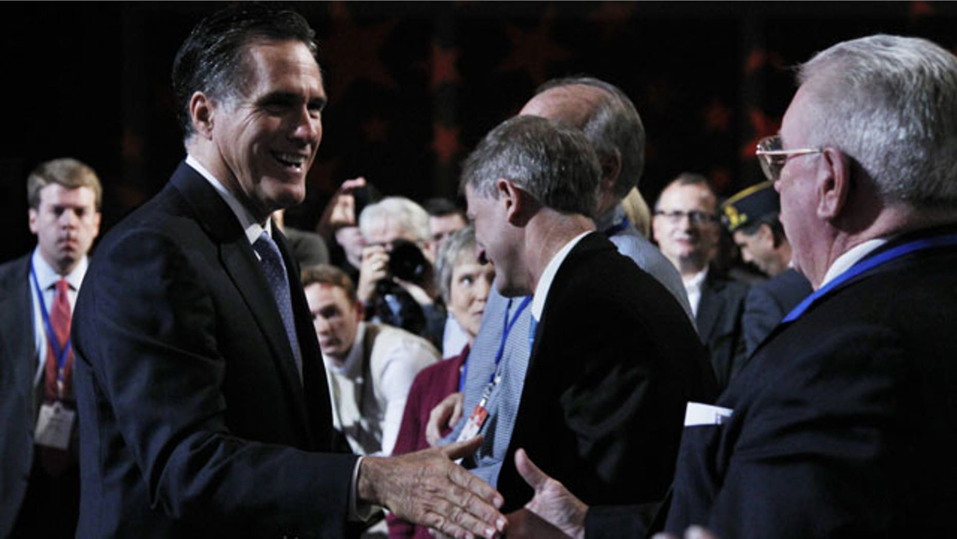 October 8: Republican presidential candidate former Governor Mitt Romney, left, greets the crowd after delivering his remarks at the Values Voter Summit in Washington.
