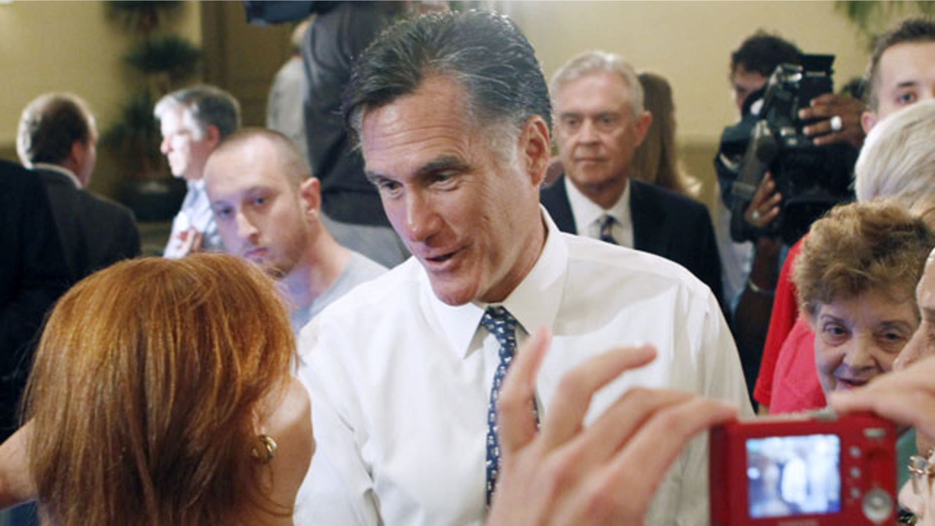 September 21: Republican presidential candidate and former Massachusetts Gov. Mitt Romney talks to a supporter after a town hall meeting in Miami.