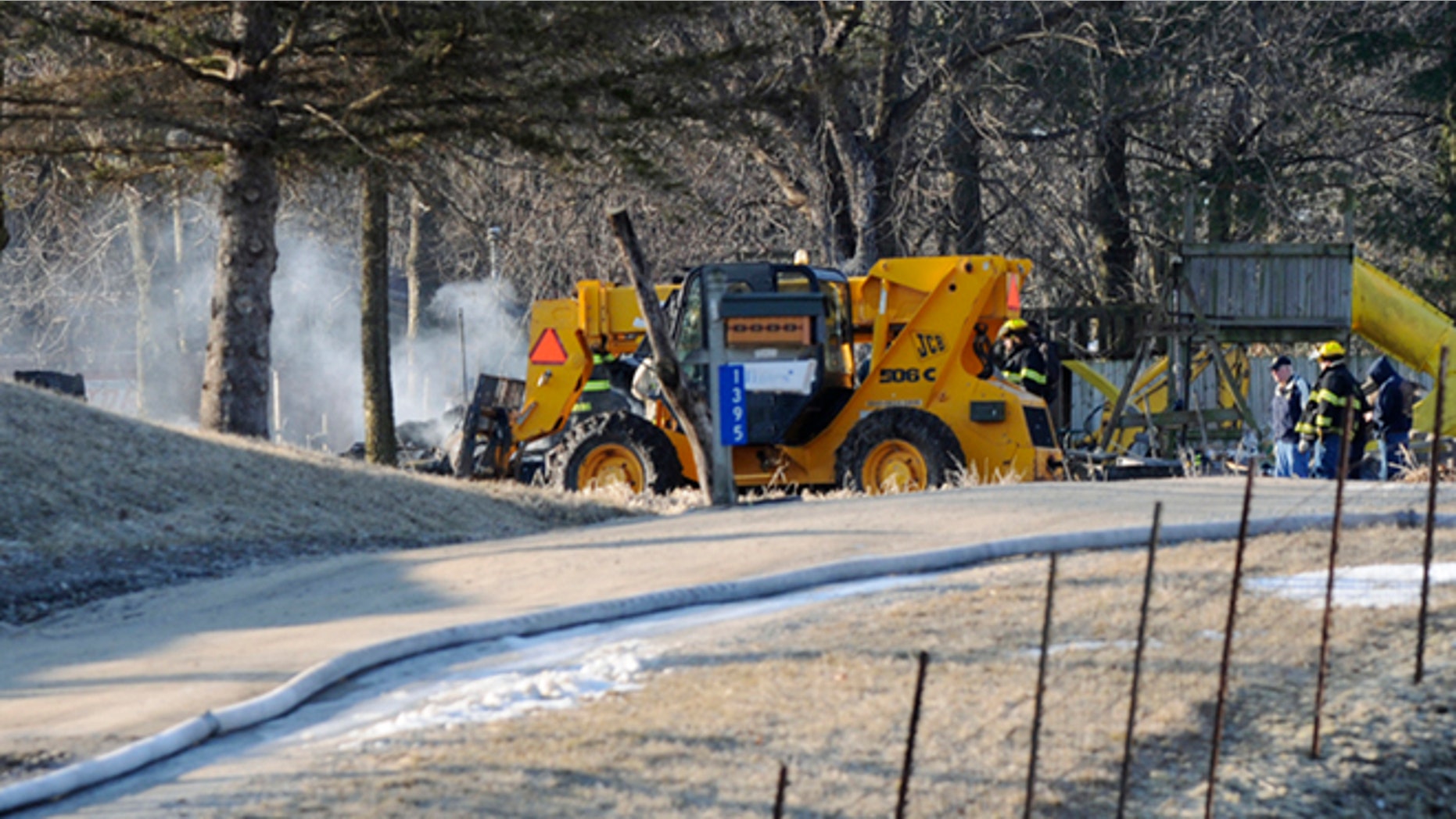 March 27: Emergency personnel are shown near the scene of a fatal mobile home fire in Sherrard, Ill.