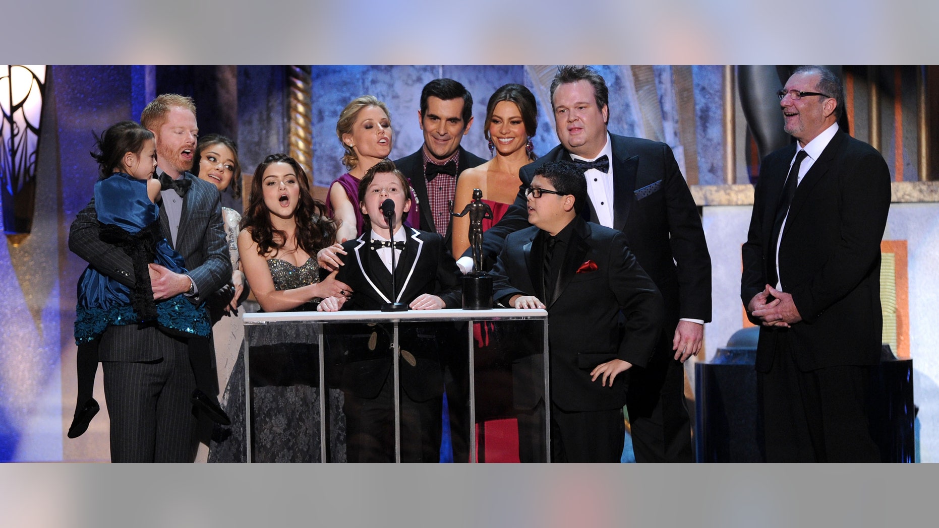LOS ANGELES, CA - JANUARY 29: The cast of 'Modern Family' accept the Outstanding Performance by an Ensemble in a Comedy Series award for 'Modern Family' onstage during the 18th Annual Screen Actors Guild Awards at The Shrine Auditorium on January 29, 2012 in Los Angeles, California. (Photo by Kevin Winter/Getty Images)