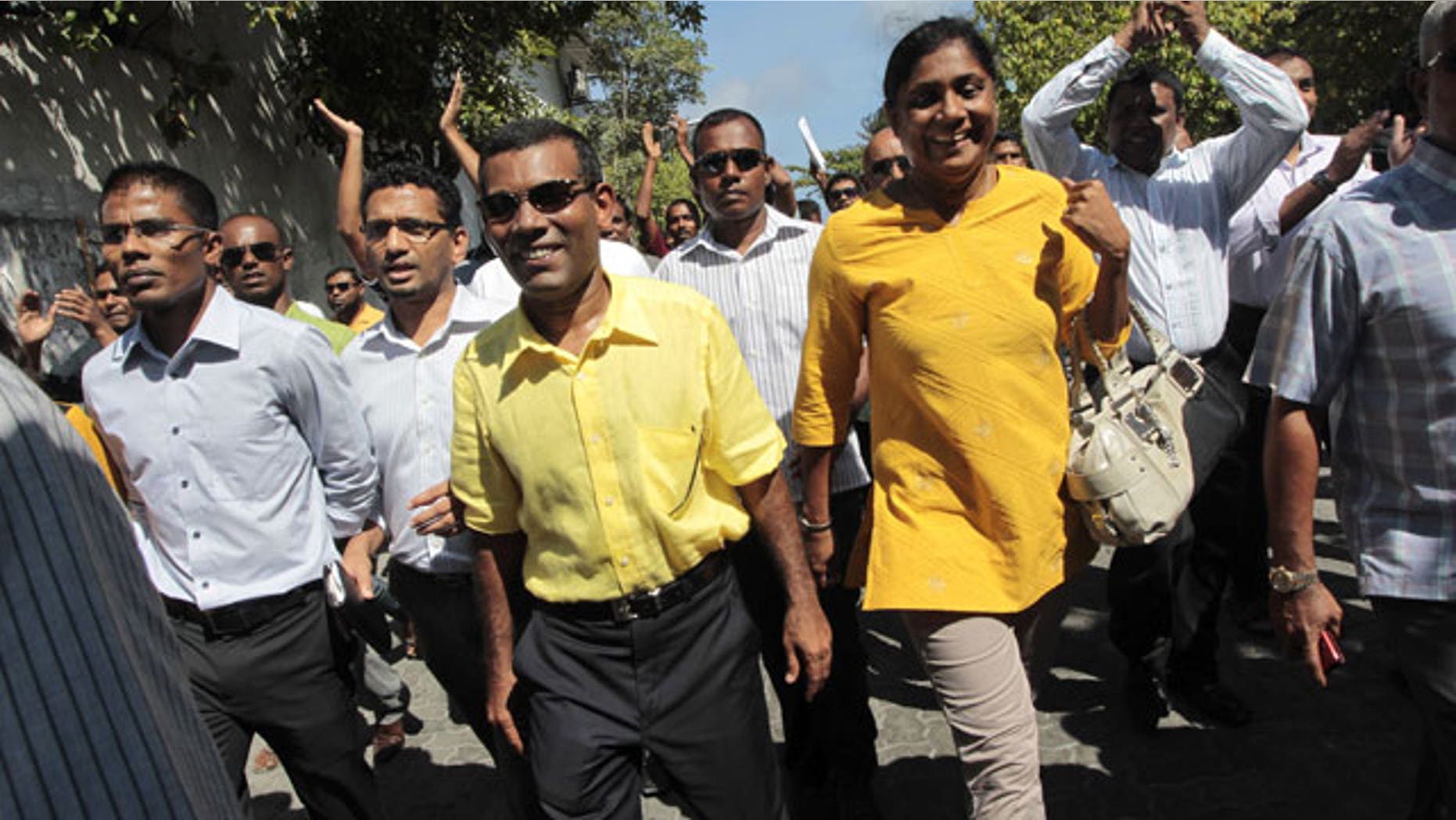 Feb. 8, 2012: Mohamed Nasheed, yellow shirt front center, who resigned Tuesday from his post as Maldivian President, marches along with his supporters during a rally in Male, Maldives.