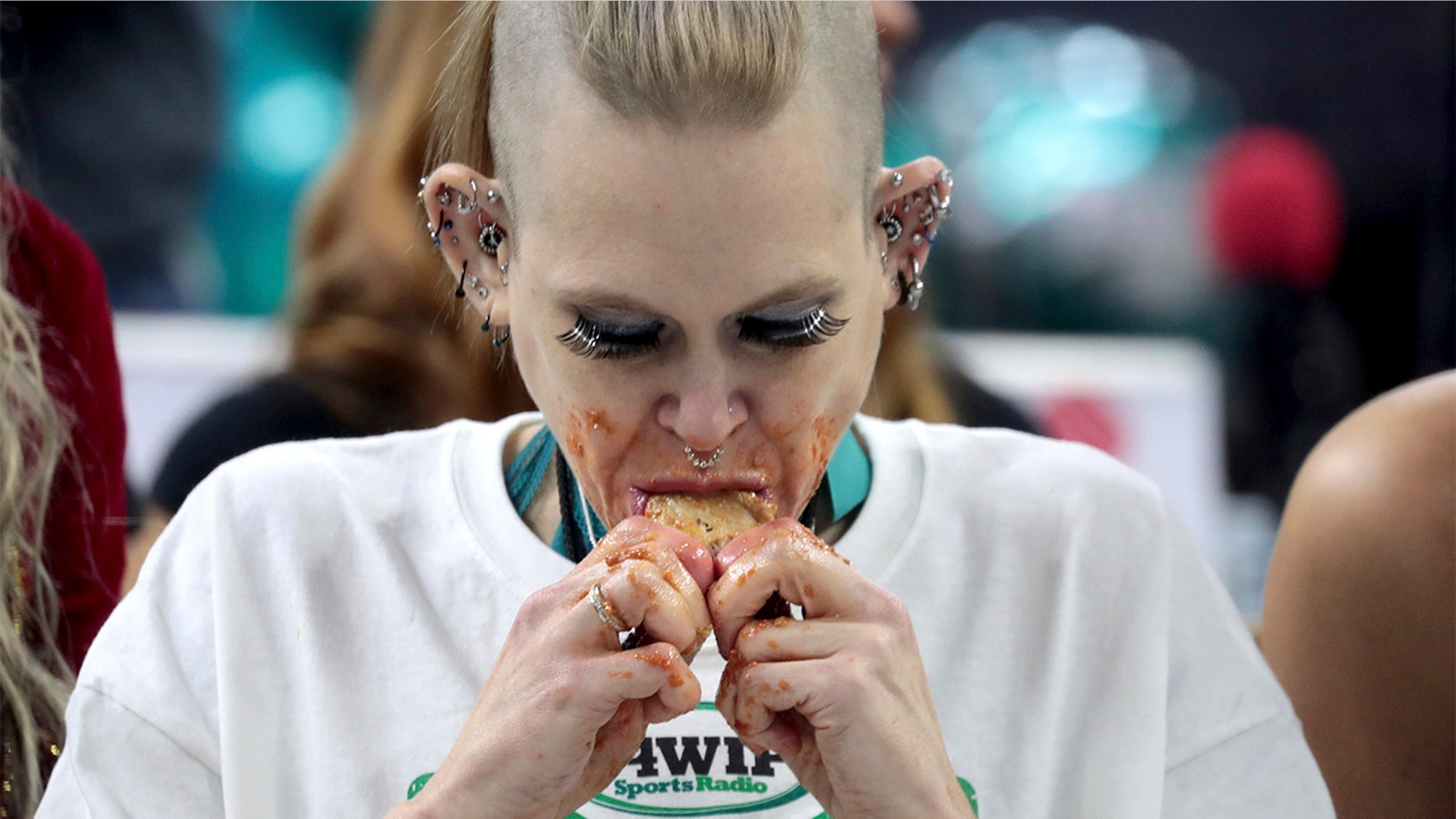 Competitive eater Molly Schuyler gnawed her way through a record 501 chicken wings in 30 minutes to win her third Wing Bowl in Philadelphia.