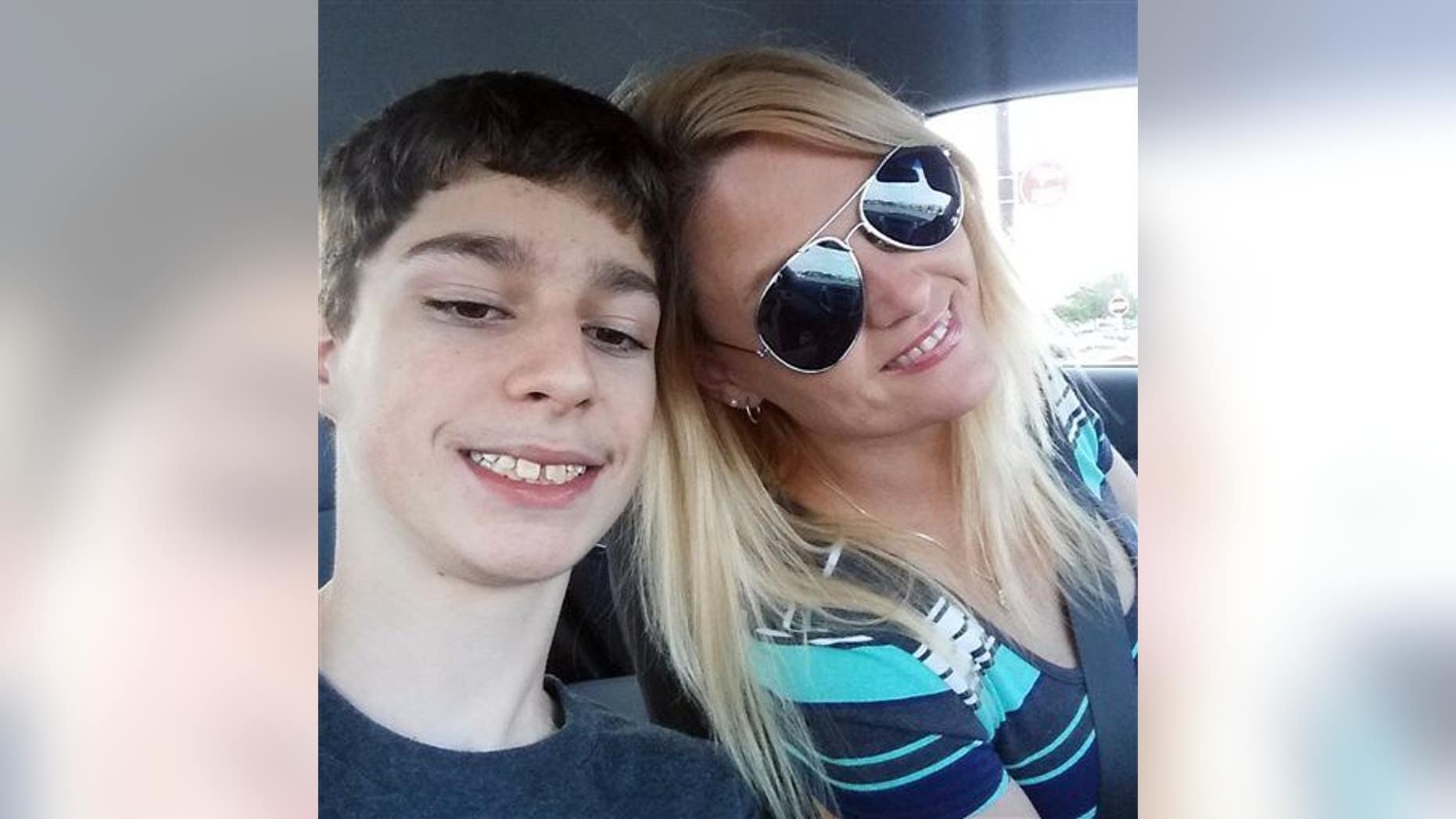 Alex Hoover poses for a photo with his mother, Rene. Alex has a terminal heart condition and has not returned to school because of what his mother says is a dispute over how he might die.