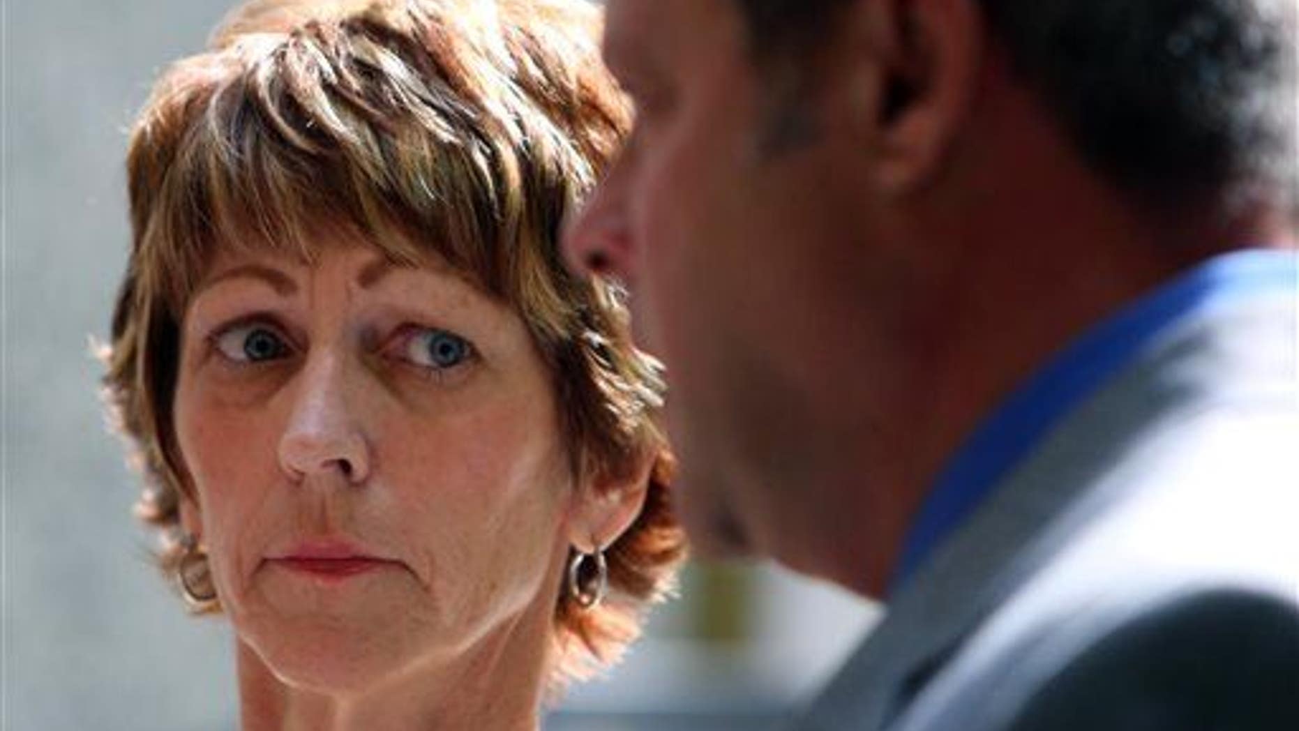 In this June 25, 2015, photo, Bonnie Liltz looks toward her attorney as he speaks to the media in Rolling Meadows, Ill.