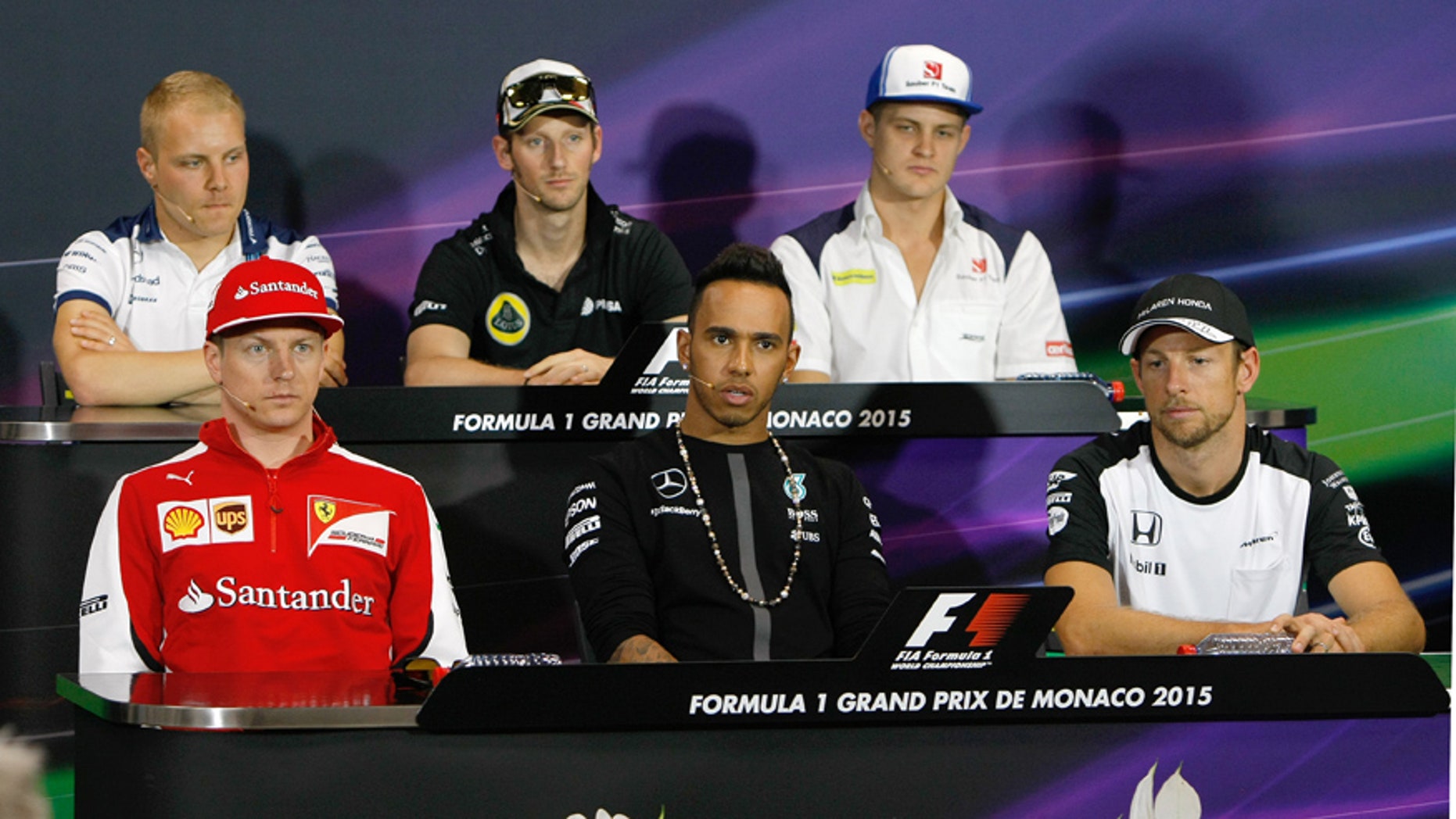 Ferrari driver Kimi Raikkonen of Finland, front left, Mercedes driver Lewis Hamilton of Britain, front center, McLaren driver Jenson Button of Britain, front right, Sauber driver Marcus Ericsson of Sweden, top left, Lotus driver Romain Grosjean of France, top center, and Williams driver Valtteri Bottas of Finland attend a press conference prior to the Formula One Grand Prix at the Monaco racetrack, in Monaco, Wednesday May 20, 2015. The Formula One race will be held on Sunday. (AP Photo/Claude Paris)