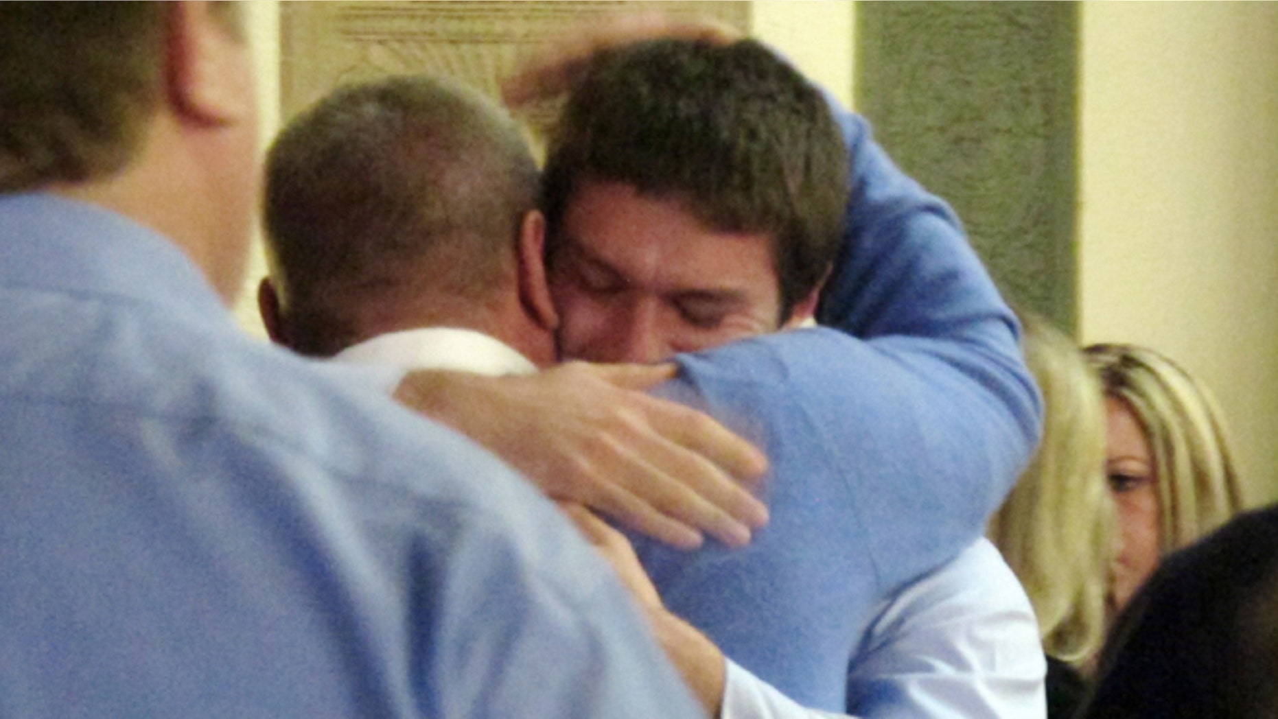 March 1: Former University of Montana quarterback, Jordan Johnson, facing camera, is hugged by a supporter after being acquitted of rape charges during his trial.