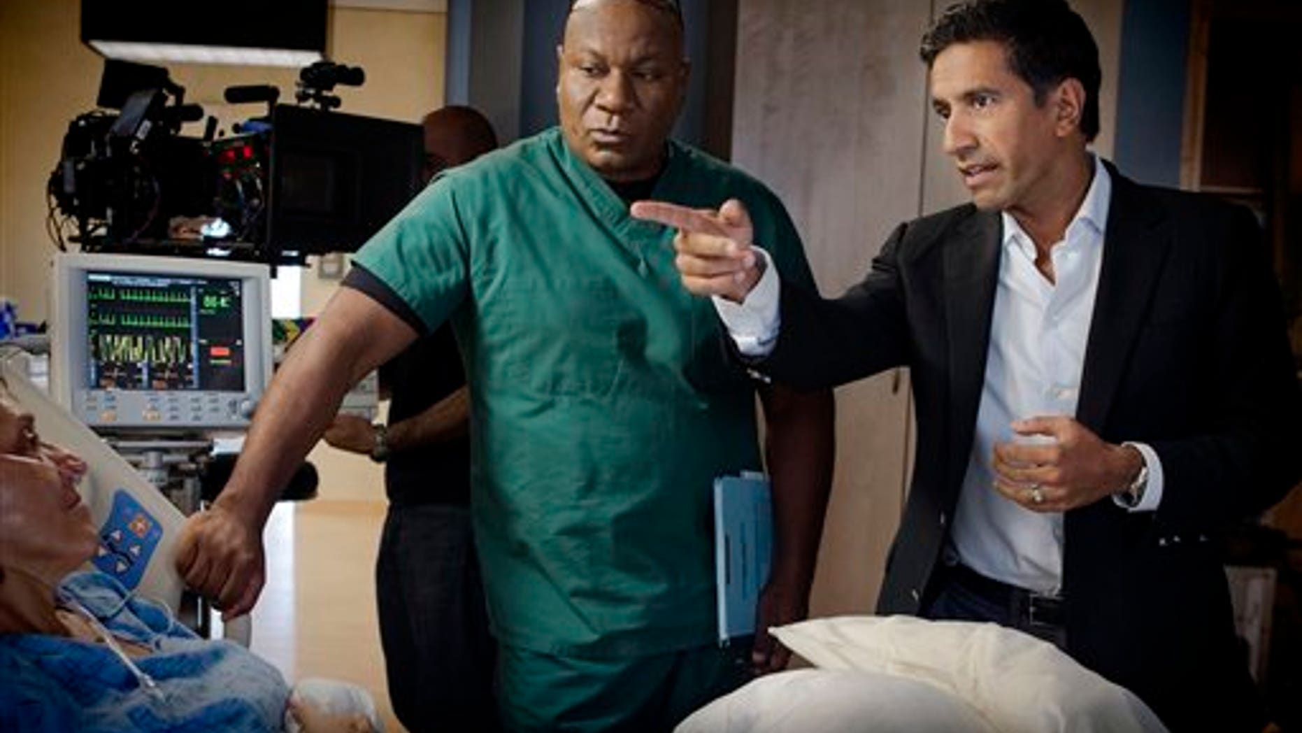 This undated image released by TNT shows Ving Rhames portraying Dr. Jorge Villanueva, left, and Executive Producer Dr. Sanjay Gupta on the set of "Monday Mornings" a medical drama premiering Monday, Feb. 4, 2013 at 10 p.m. EST on TNT.
