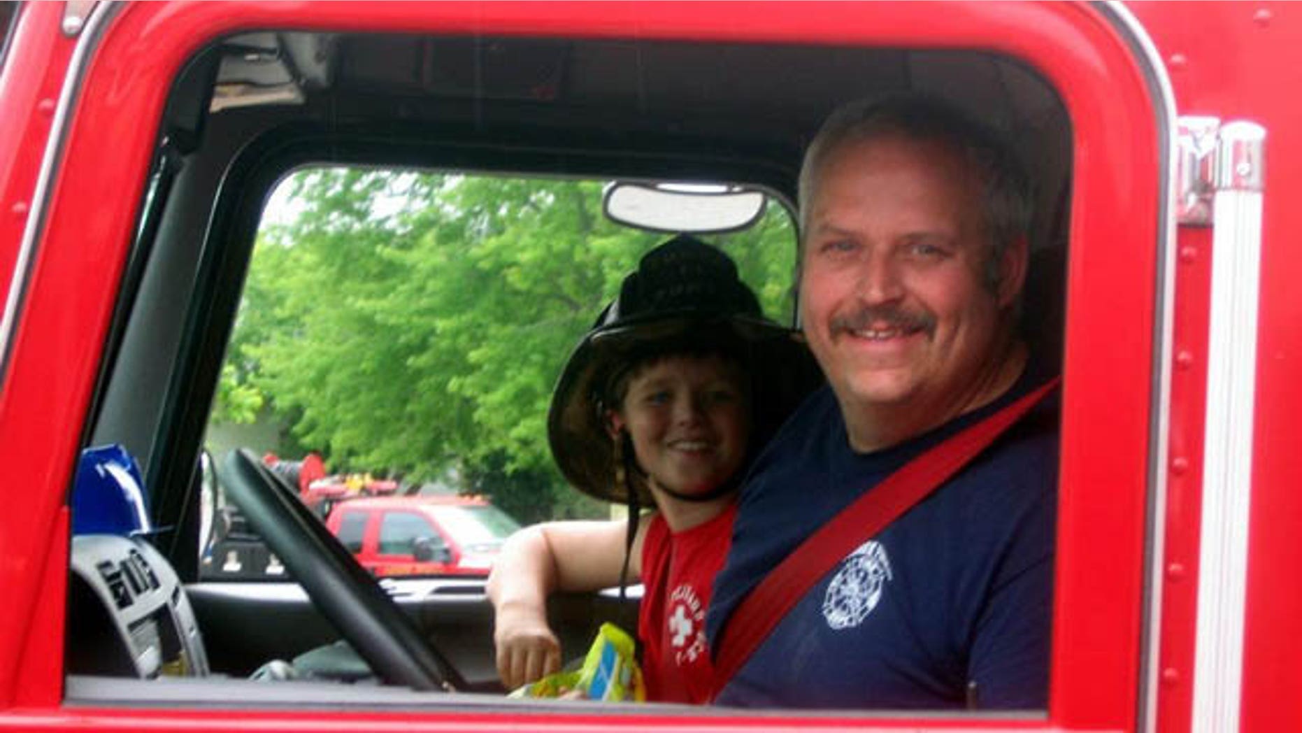 June 19, 2014: This image provided by Gallitan County Fire Department shows Chief Todd Rummel, who was killed in an accident Thursday after a fire engine and a pickup truck collided on a Montana highway, with an unidentified passenger (AP Photo/Gallitan County Fire Department)