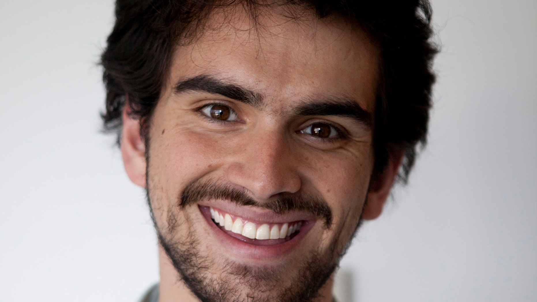 June 4, 2012: Armando Montano, 22, poses for an ID photo at the Associated Press office in Mexico City.