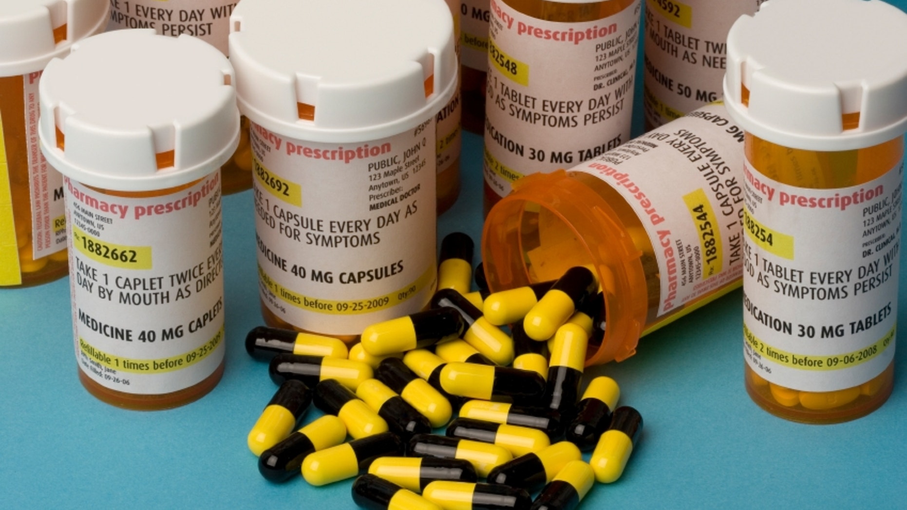 Bottles of prescription medication. Labels are fake, with false information.