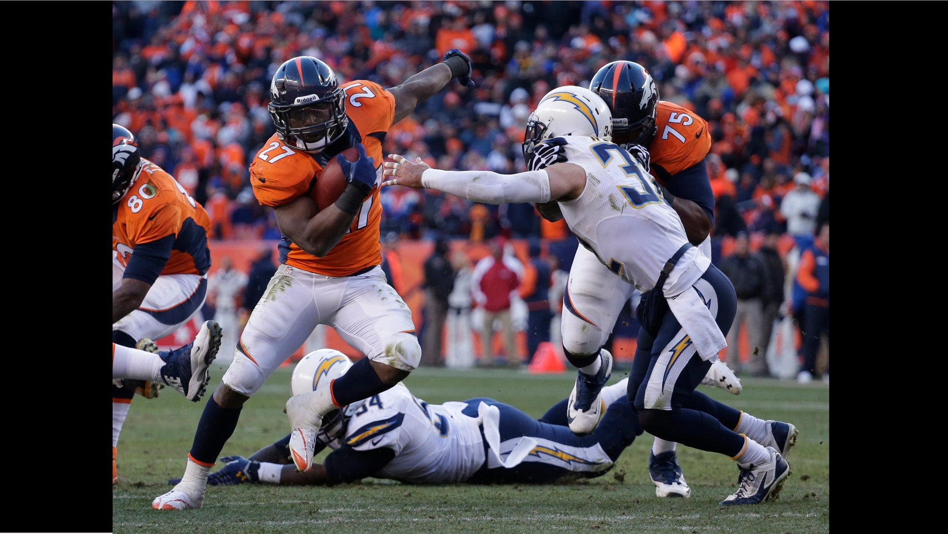 Denver Broncos running back Knowshon Moreno (27) sidesteps San Diego Chargers free safety Eric Weddle (32) in the second quarter of an NFL AFC division playoff football game, Sunday, Jan. 12, 2014, in Denver. (AP Photo/Charlie Riedel)