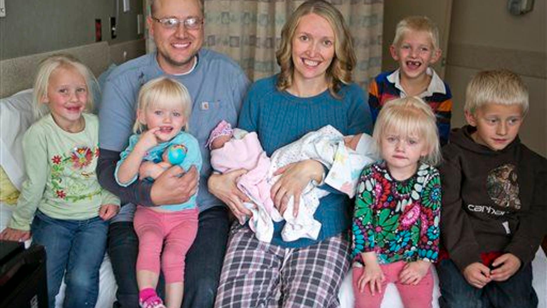 Tiffany and Chris Goodwin of Three Forks, Mont., pose with their children, including 3 sets of twins.