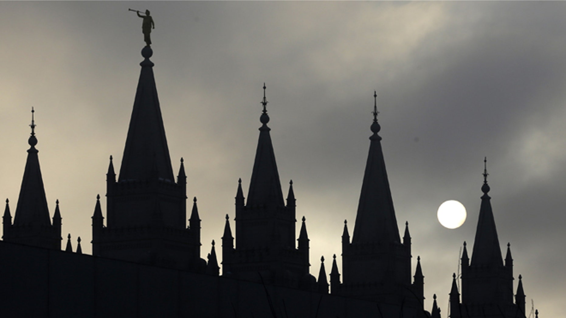FILE: The angel Moroni statue, silhouetted against a cloud-covered sky, sits atop the Salt Lake Temple in Temple Square in Salt Lake City.