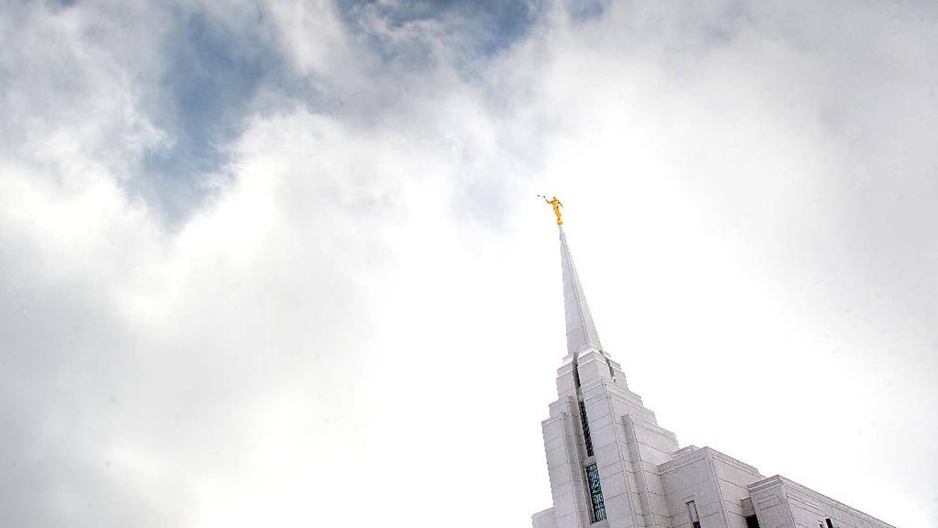 FILE - This December, 2007, file photo, shows the Mormon Temple in Rexburg, Idaho. A newly-posted article, part of a series of recent online articles posted on the website of The Church of Jesus Christ of Latter-day Saints, affirms the Mormon faith's belief that humans can become like God in eternity, but explains that the "cartoonish image of people receiving their own planets" is not how the religion envisions it. (AP Photo/Amanda Smith, File)