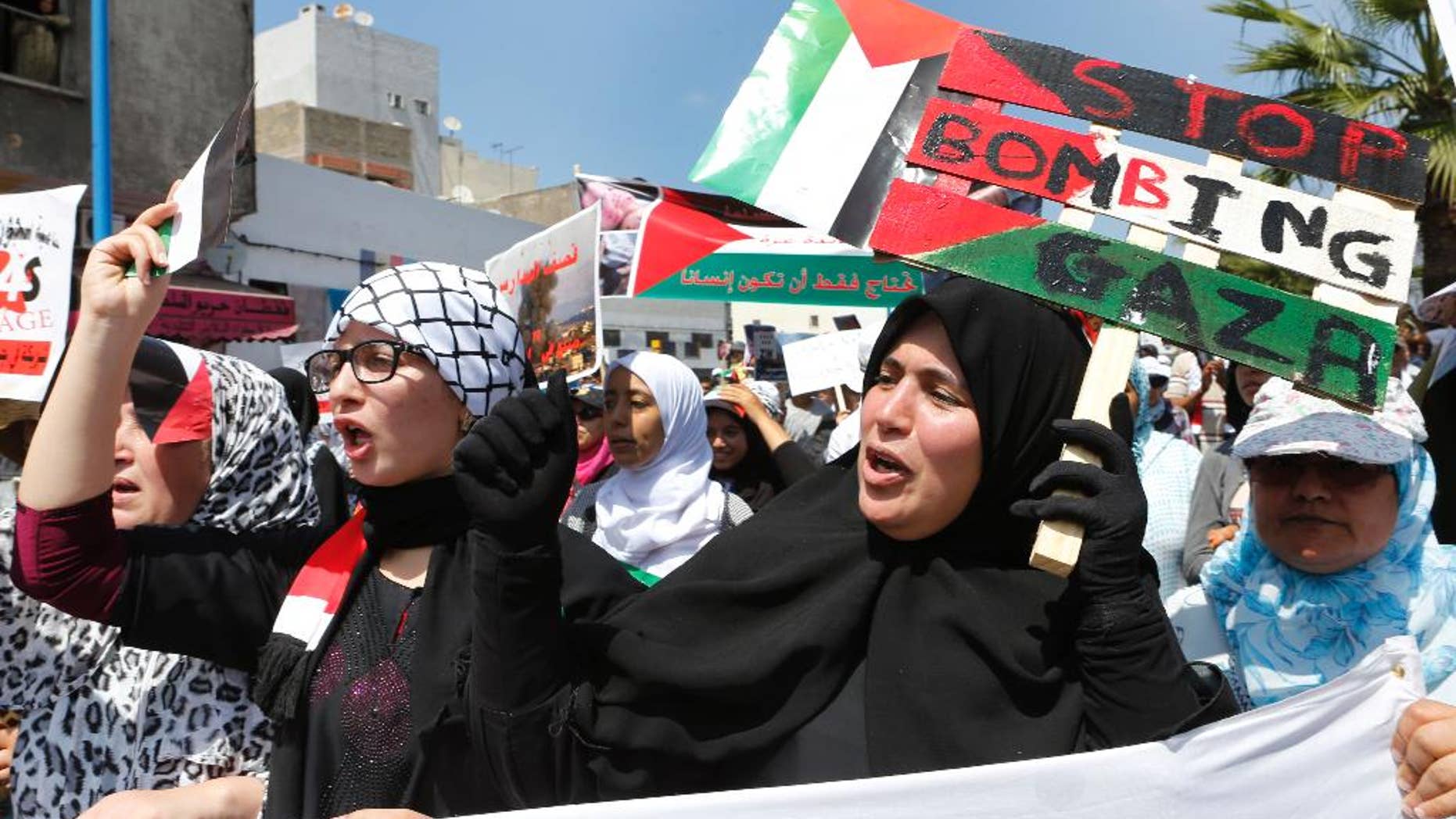Thousands of pro-Palestinian demonstrators holds banners and shout slogans during a protest against the Israeli offensive on the Gaza Strip, in the streets of Casablanca, Morocco, Sunday, July 27, 2014. Israel and Hamas launched new attacks Sunday in the raging Gaza war, despite each side offering different truces to temporarily halt nearly three weeks of fighting ahead of a major Muslim holiday. (AP Photo/Abdeljalil Bounhar)