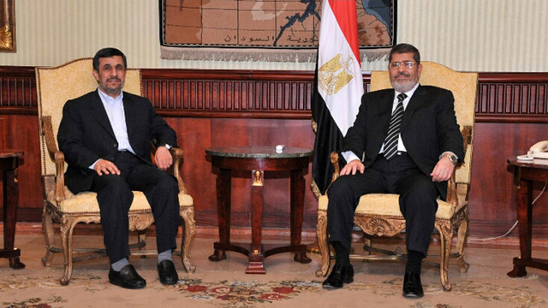 Feb. 5, 2013: Iran's President Mahmoud Ahmadinejad, left, and Egyptian President Mohammed Morsi, right, pose for photographers in Cairo, Egypt.