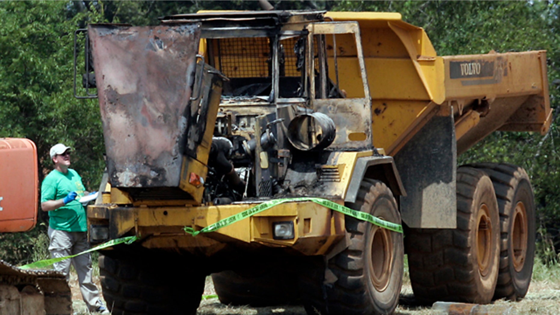 Aug. 28. 2010: Rutherford County Sheriff's Office and ATF investigators examine equipment damaged in a fire at the future site of the Islamic Center of Murfreesboro. Authorities told mosque officials that four pieces of heavy construction equipment on the site were doused with an accelerant and one set ablaze, said Camie Ayash, spokeswoman for the Islamic Center of Murfreesboro.