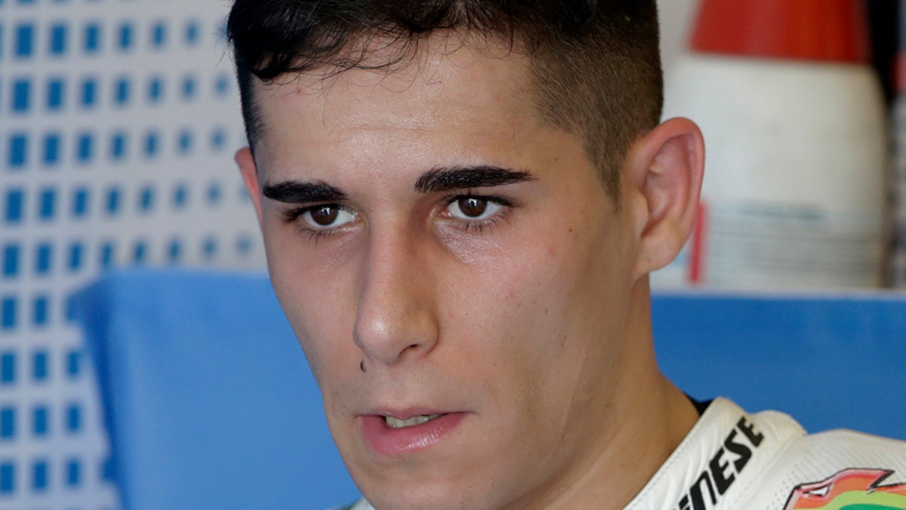 FILE, In this Friday, April 11, 2014 file photo, Luis Salom of Spain talks with team members in the garage area at the Circuit of Americas track during open practice for the Grand Prix of the Americas MotoGP motorcycle race in Austin, Texas. (AP Photo/Tony Gutierrez, File)