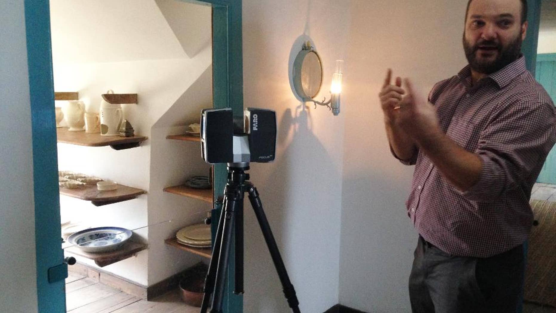 Joe Nicoli, a scanning specialist with Direct Dimensions Inc. of Owings Mills, Maryland, stands on the second floor of George Washington's Mount Vernon estate Thursday, Feb. 12, 2015, as he explains the laser scanning technology used at Mount Vernon to develop highly detailed images of the mansion that will be used to guide future restoration efforts. Architects and preservationists are at the estate building a computerized database of every piece of the mansion. Laser scans are recording three-dimensional images to the tiniest detail, and workers are crawling on their hands and knees to photograph and document key components. (AP Photo/Matt Barakat)