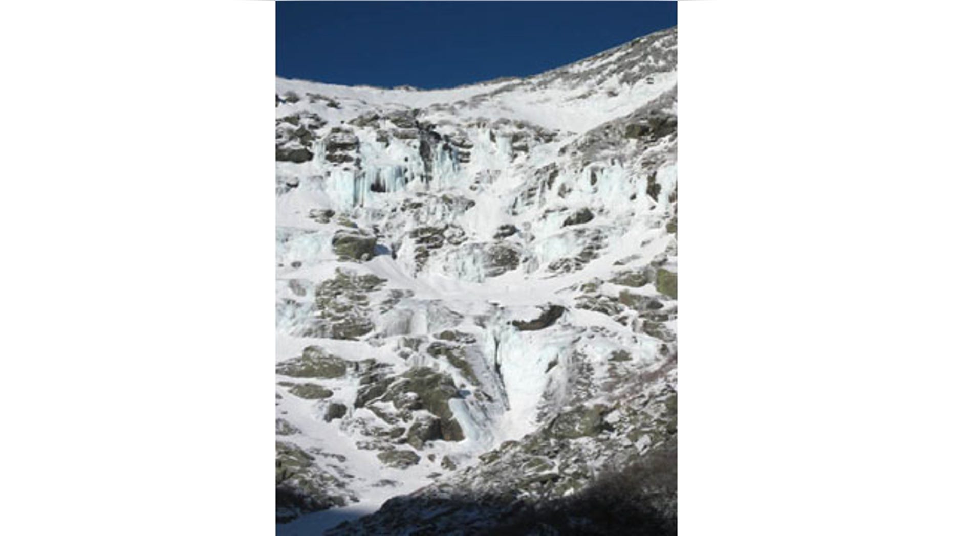 December 24, 2013: This photo released by the U.S. Forest Service shows the Lip area of Mount Washington. The Lip is the section in the upper right corner. A previous avalanche crown line is visible at the top of this snowfield. This is the approximate location of where the recent avalanche was triggered. Two hikers who triggered an avalanche on Mount Washington that carried them 800 feet over rocks, cliffs and ice were rescued early Sunday, Dec. 29, 2013, and treated for non-life-threatening injuries, officials said. (AP Photo/ U.S. Forest Service)